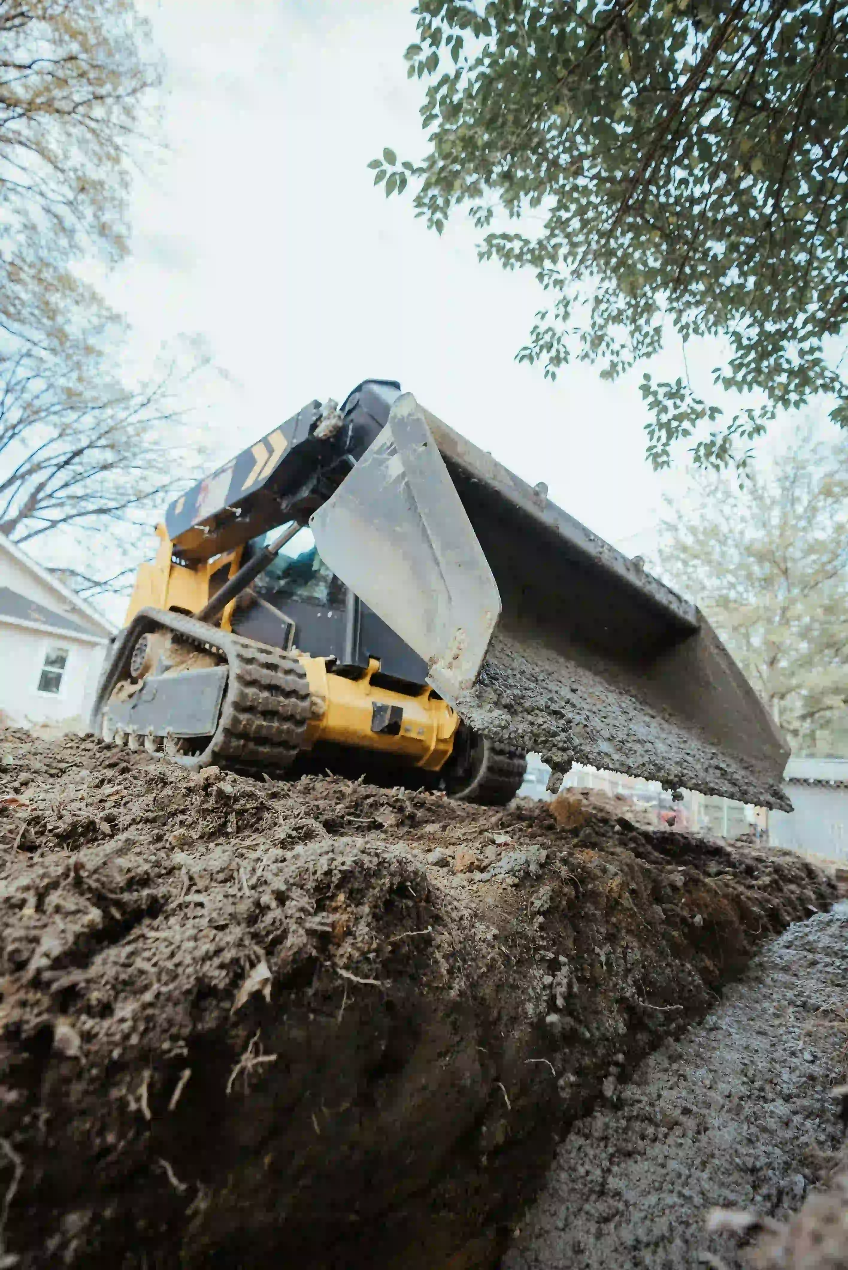 Compact excavation equipment preparing a residential site