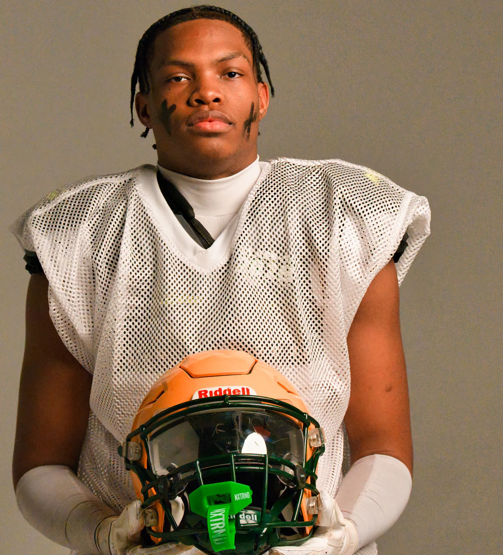 Football athlete holding helmet at 757 Dream Lab Studio