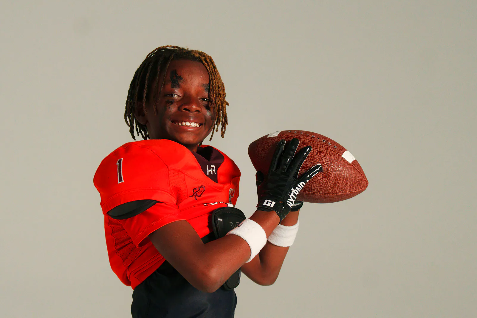 Smiling football athlete in red uniform at 757 Dream Lab Studio