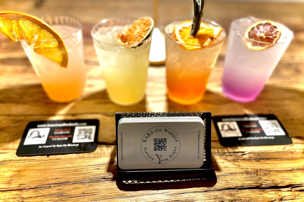 Bars on Wheels colorful cocktails displayed with branded cards at stylish event drink station