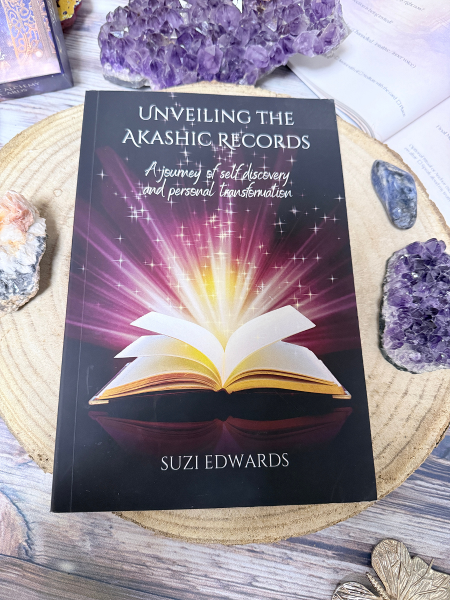 Unveiling the Akashic Records book by Suzi Edwards shown with crystals and sacred tools