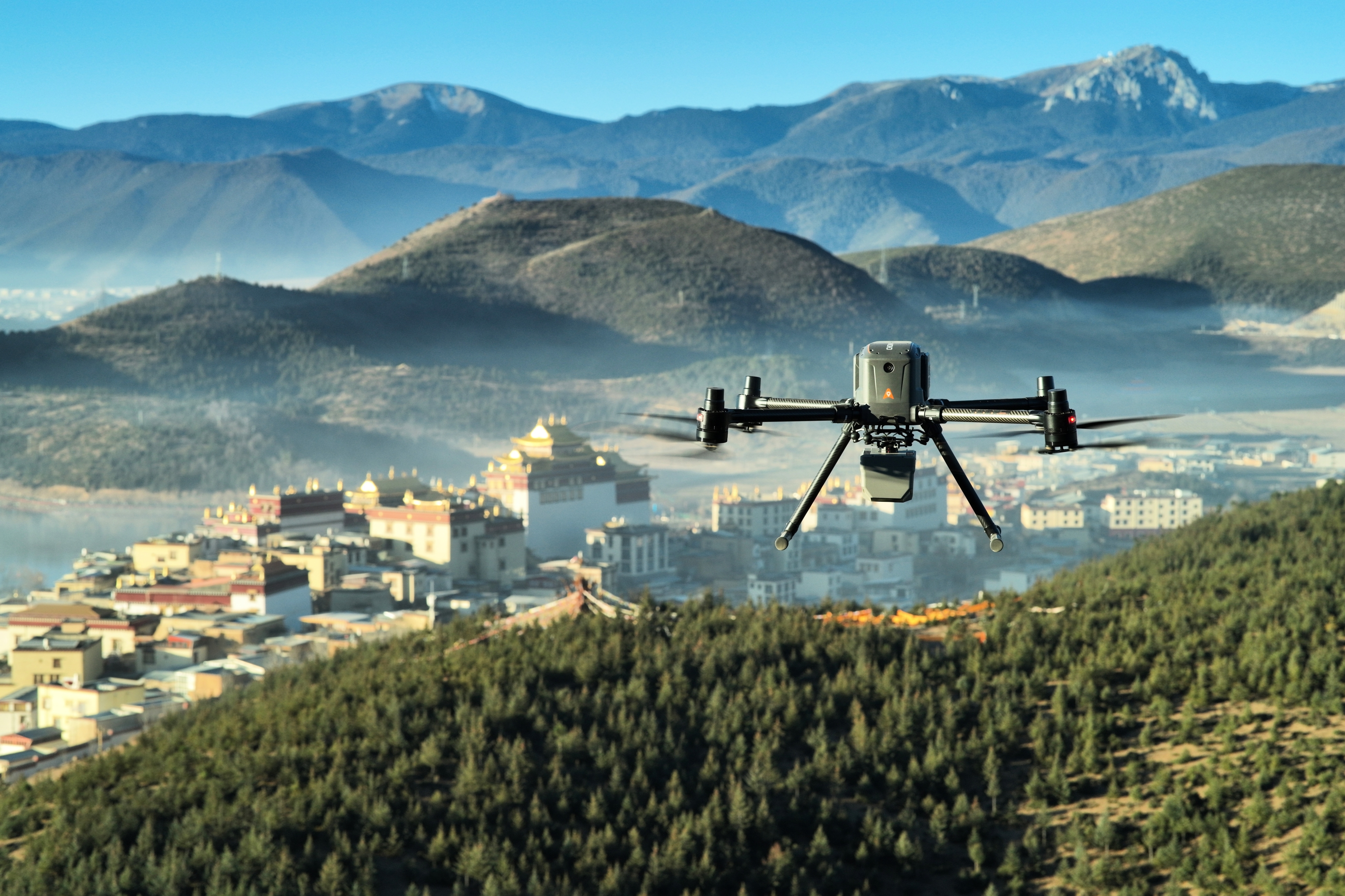 CHCNAV X500 survey drone with AlphaAir payload above a mountain landscape