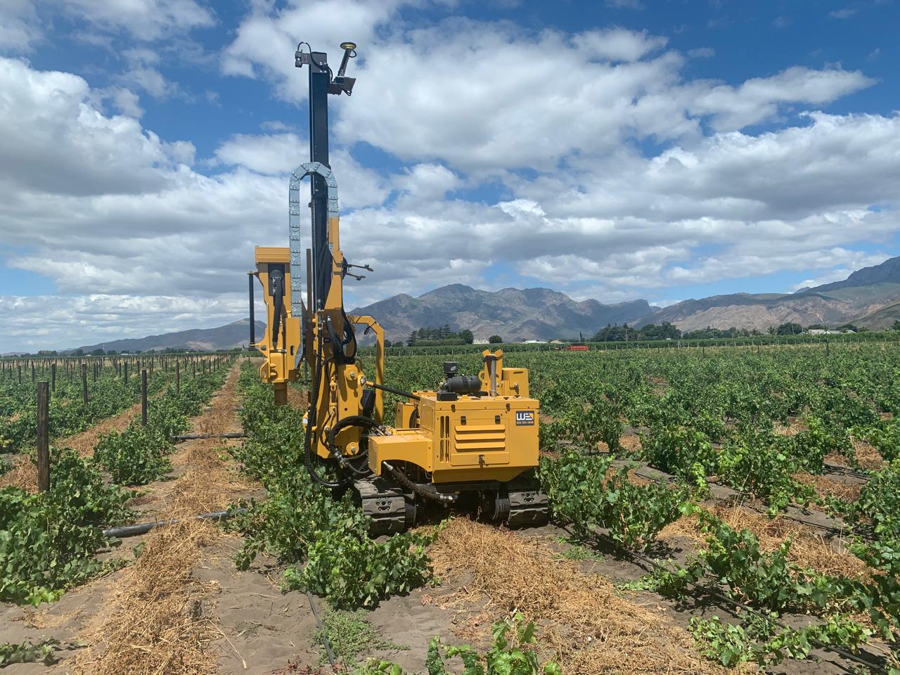 GNSS-equipped post-installation machine working between vineyard rows