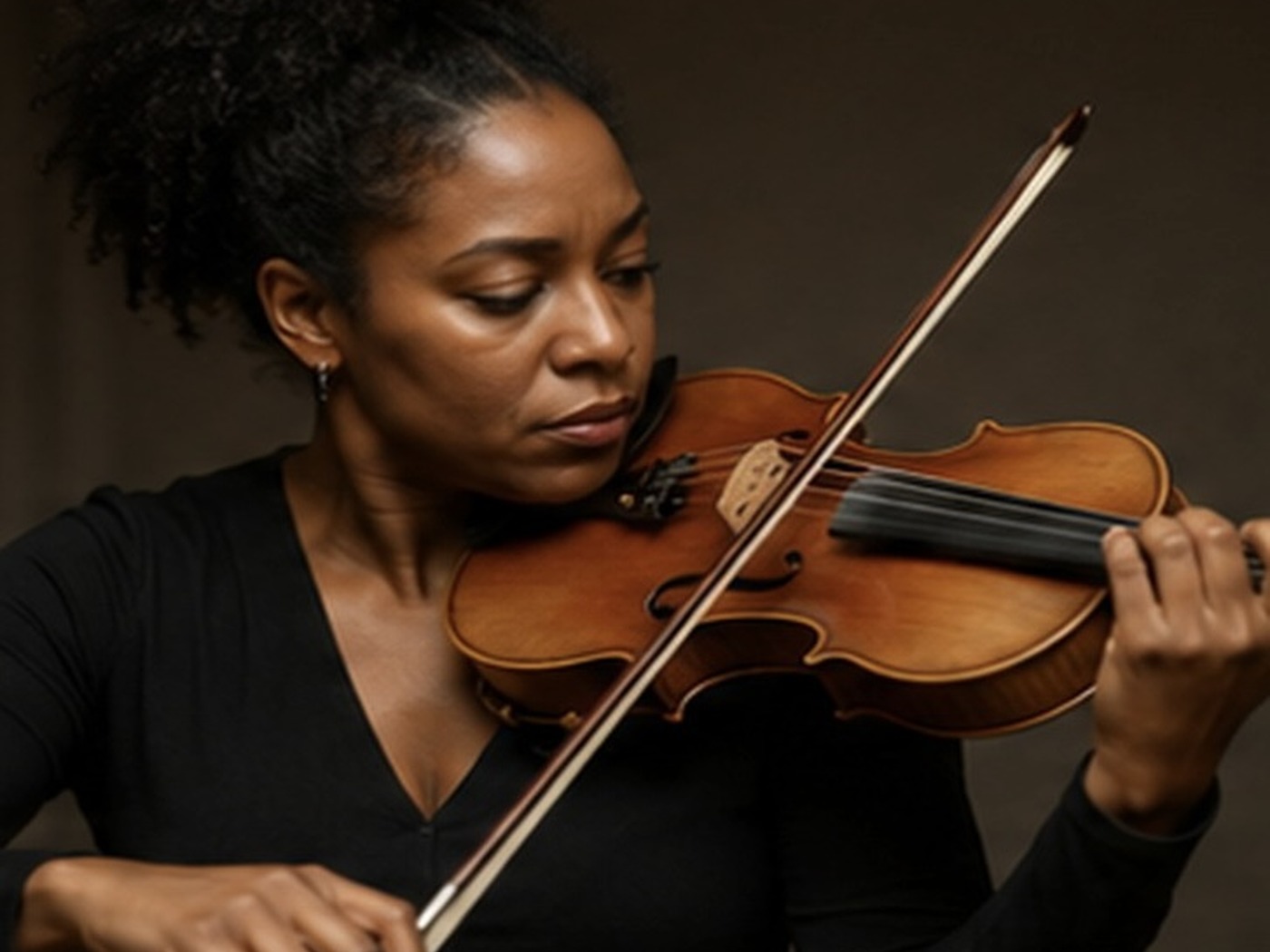 Adult violin learner studying with an online resource