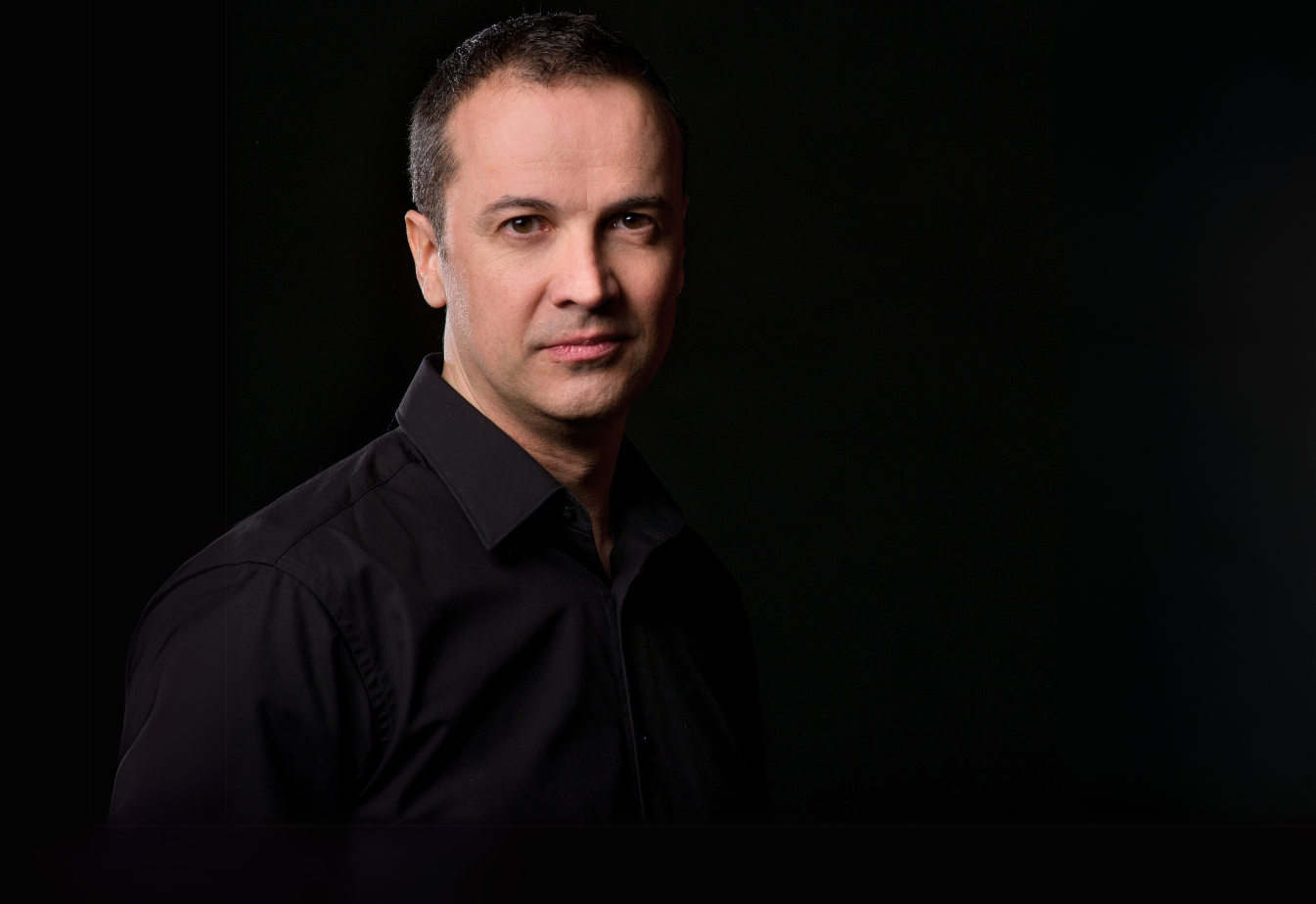 Press portrait of Cristo Barrios against a black background