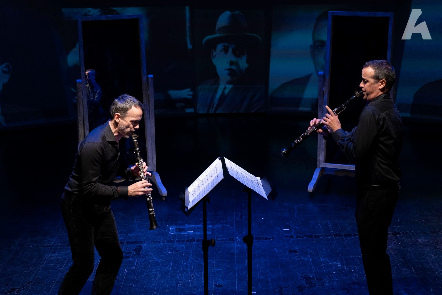 Two clarinettists performing together on stage