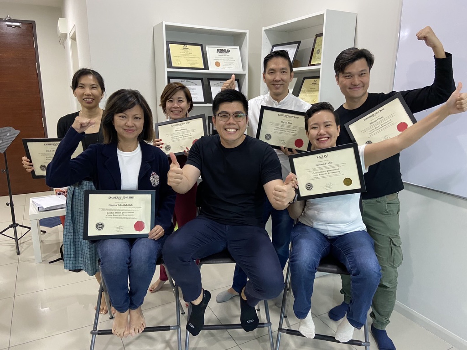 Khai Zen with a graduating class, everyone holding their certificates