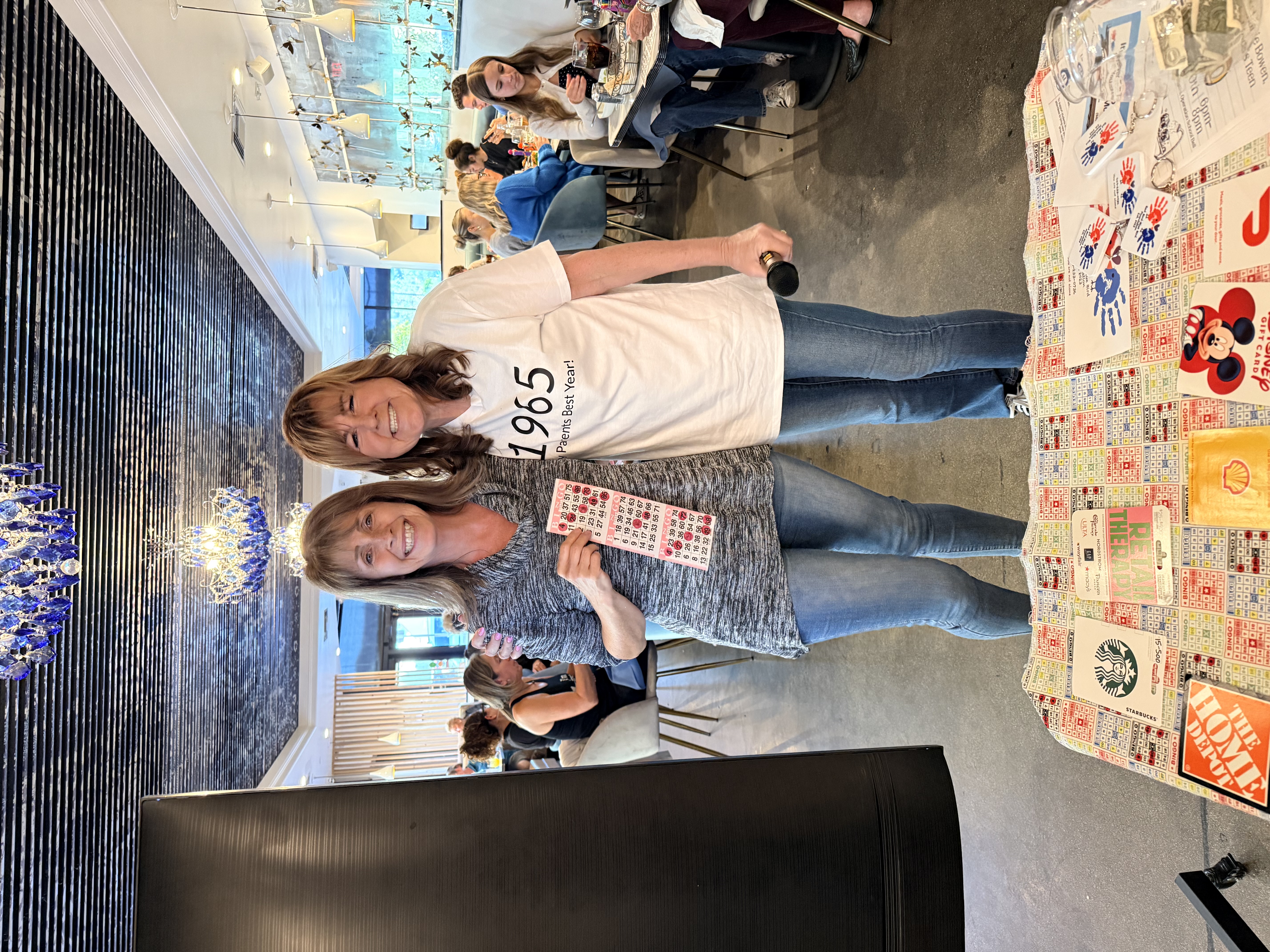 Kim with a Bingo winner holding her winning card