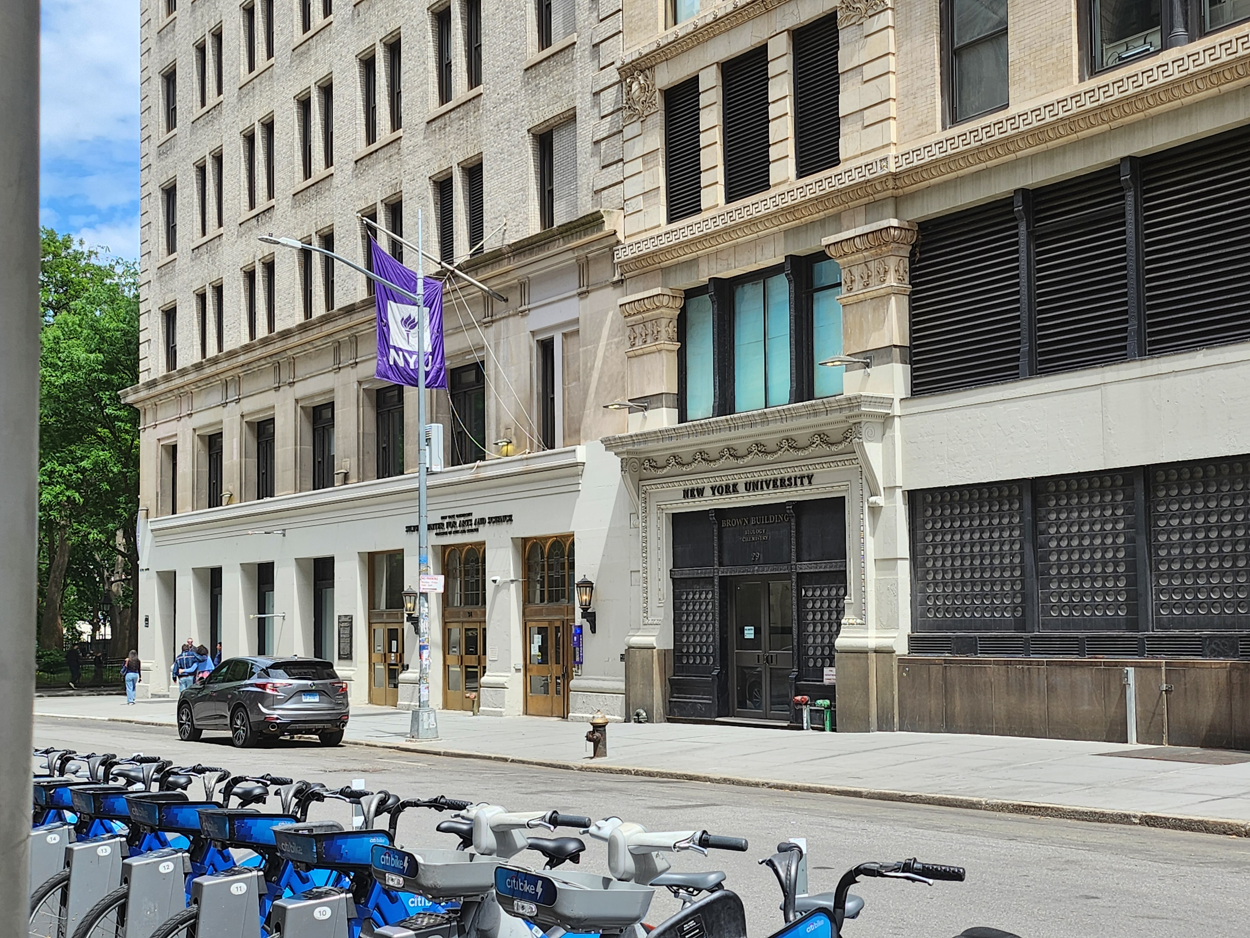 New York University purple torch flag on a Greenwich Village street New York University purple torch flag on a Greenwich Village street