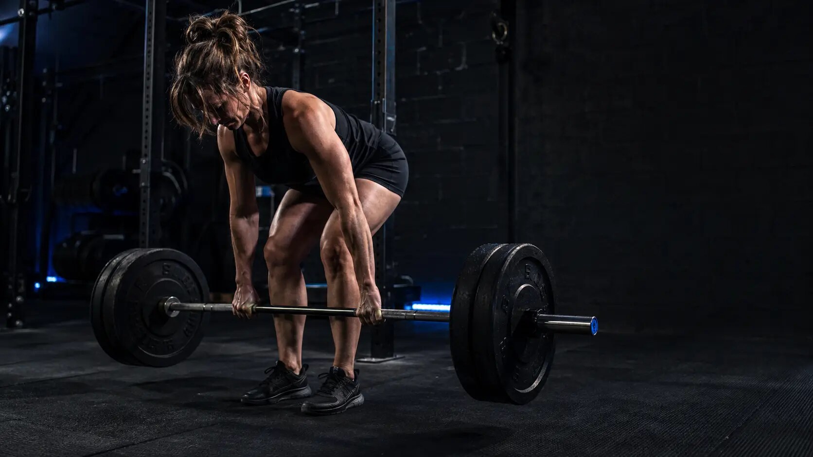 Athlete pushing a weighted sled in a strength gym