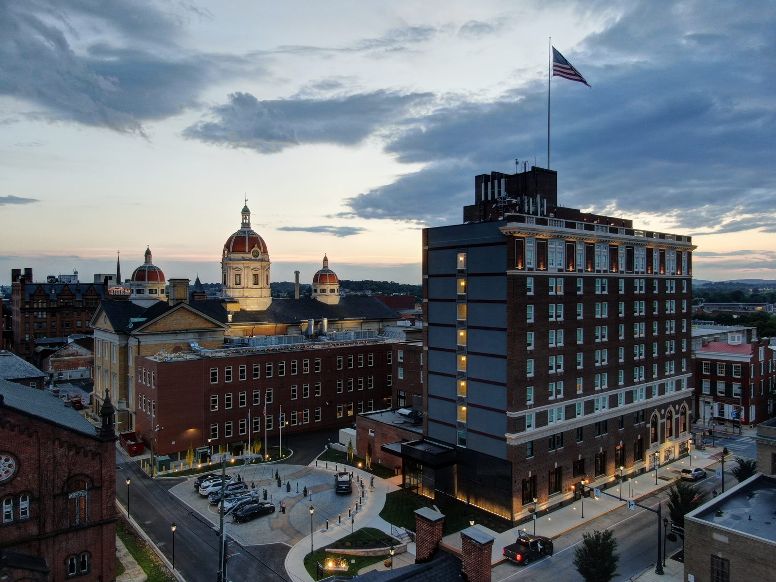 Aerial photo at dusk of the Yorktowne Hotel with the York County Courthouse behind it