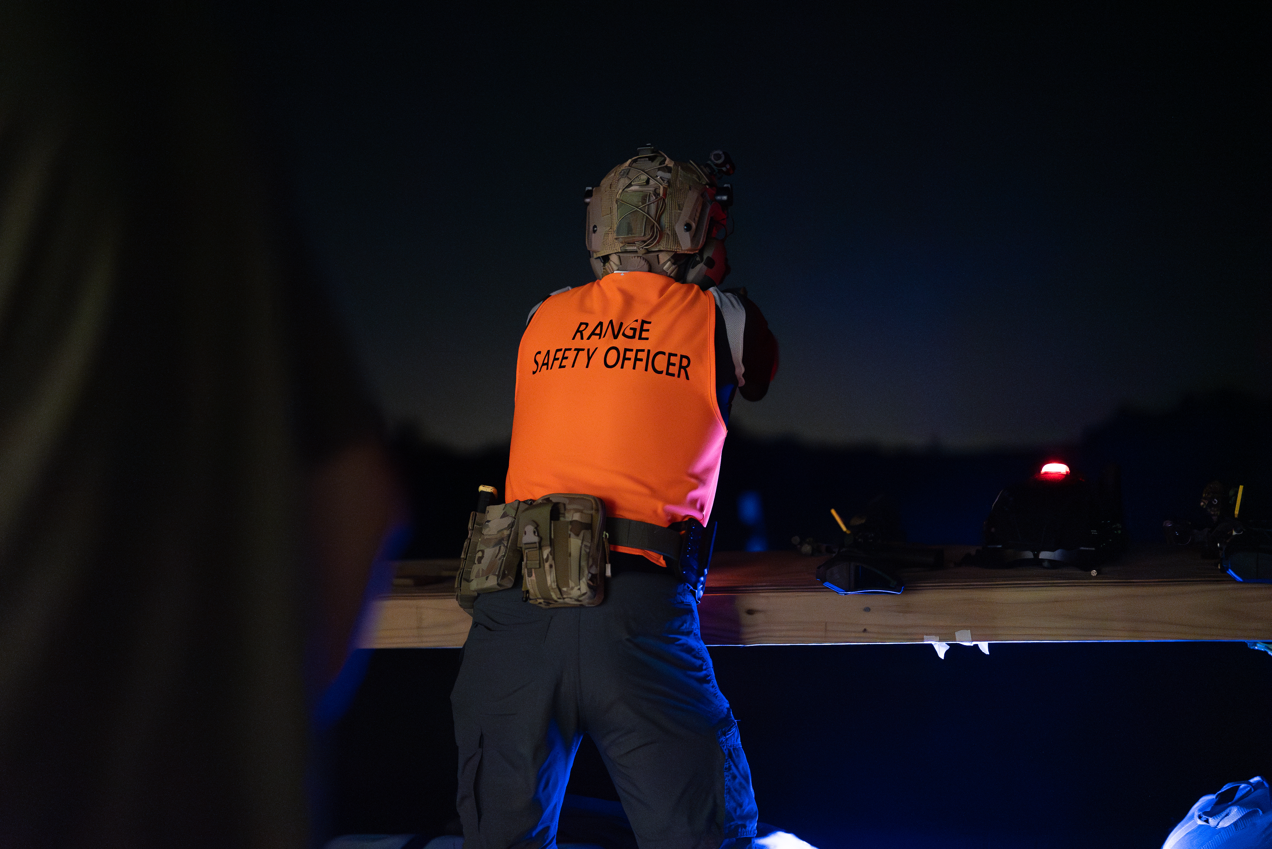 Range safety officer running the line at a Manatee Gun and Archery Club night match