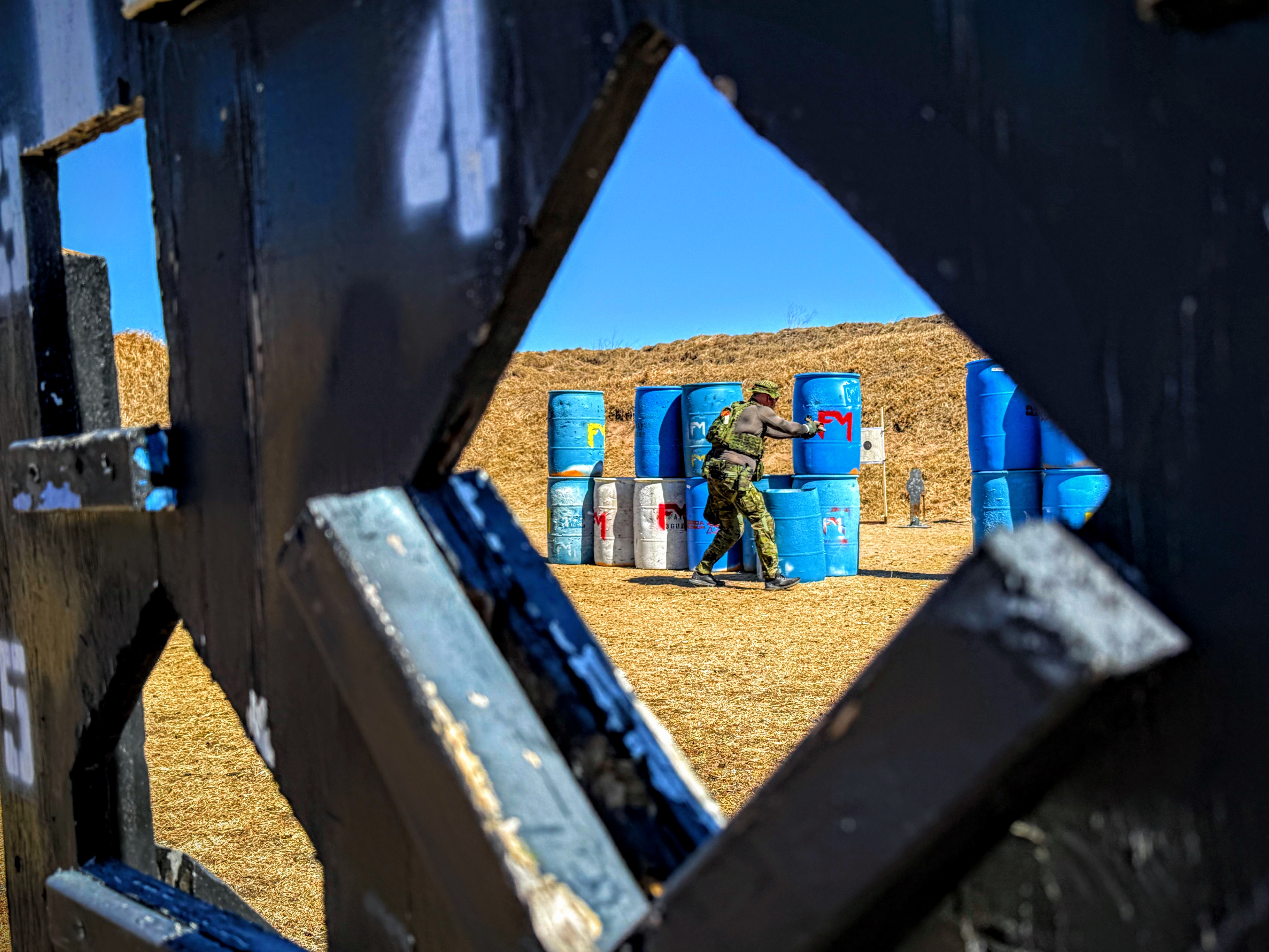 View through a barricade toward steel targets on an MGAC bay