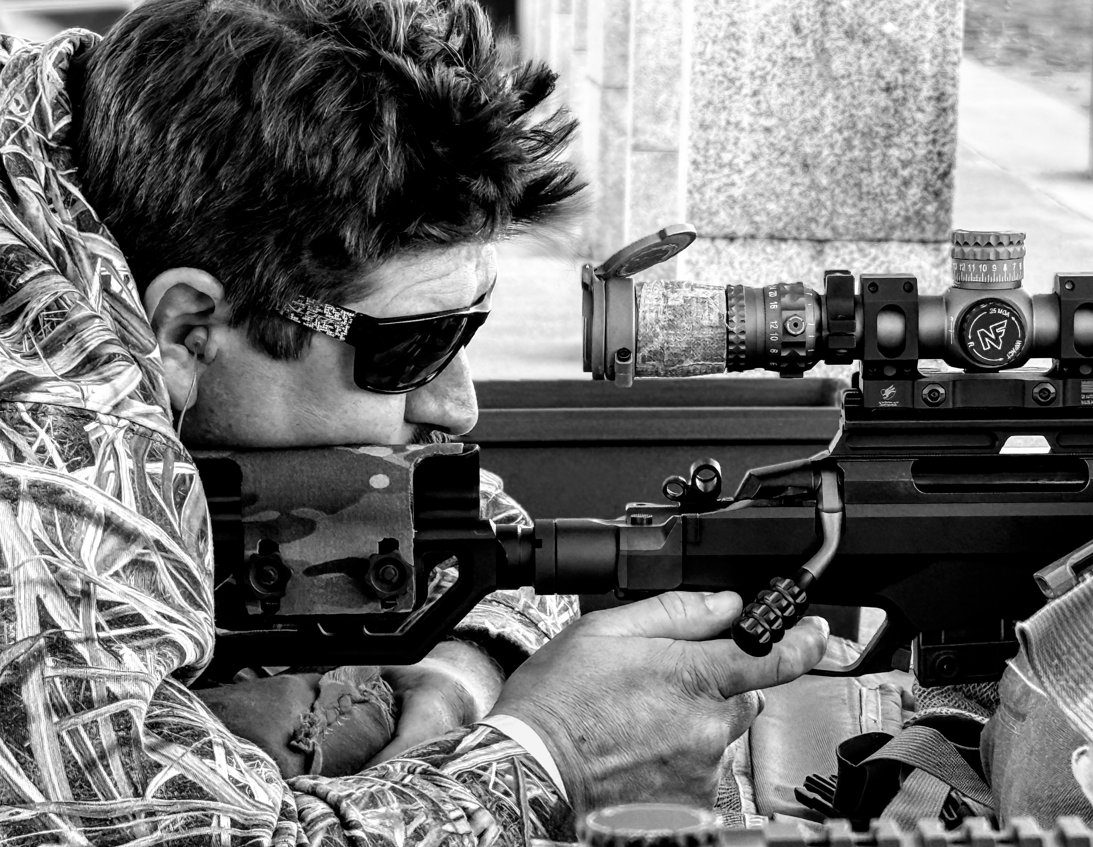 Shooter behind a scoped rifle on the MGAC line