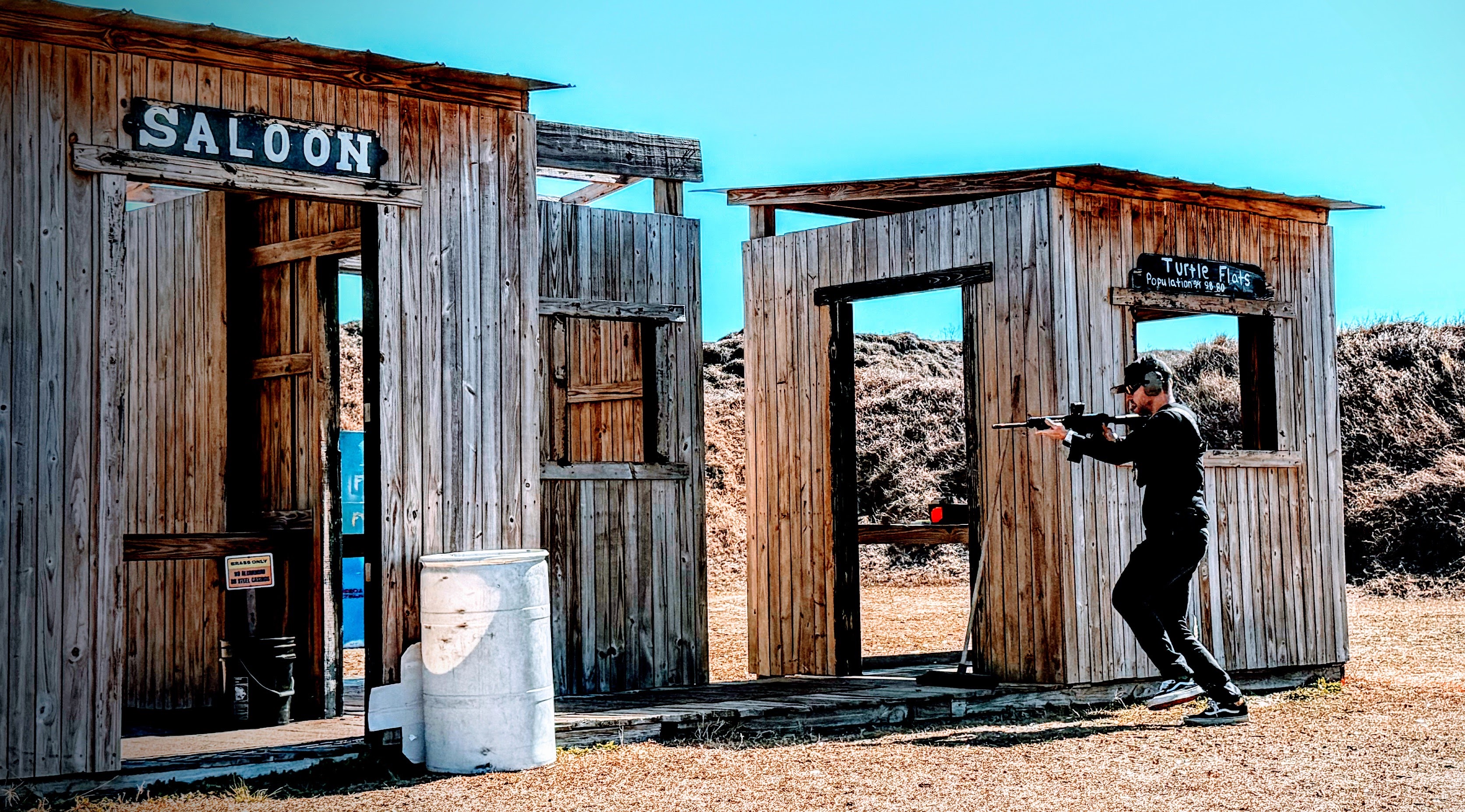 Competitor shooting through the saloon facade on the action bay