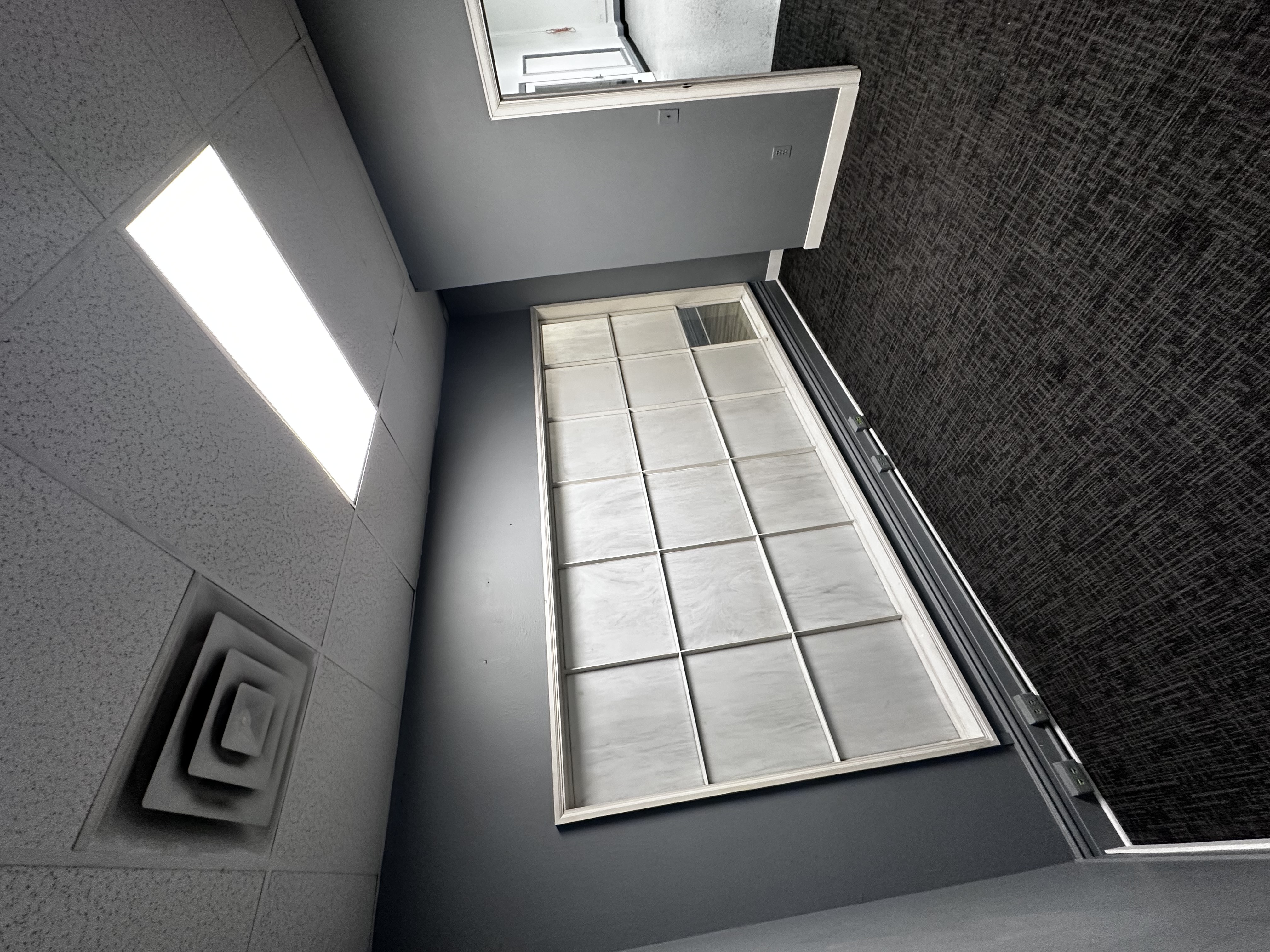 Suite 328 private side office with gray walls and frosted-glass interior windows