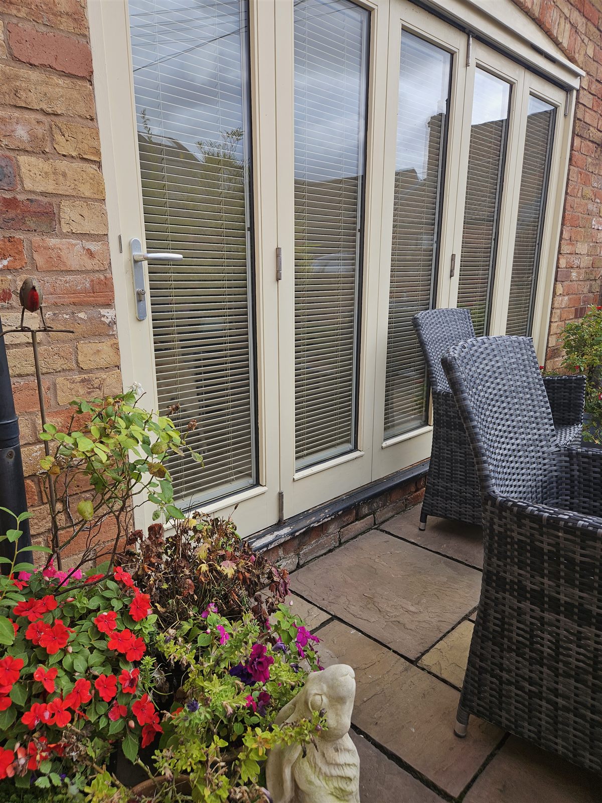 Bi-fold doors with Fit to Frame wood venetian blinds seen from the patio, fitted by Eclipse SBC in Retford