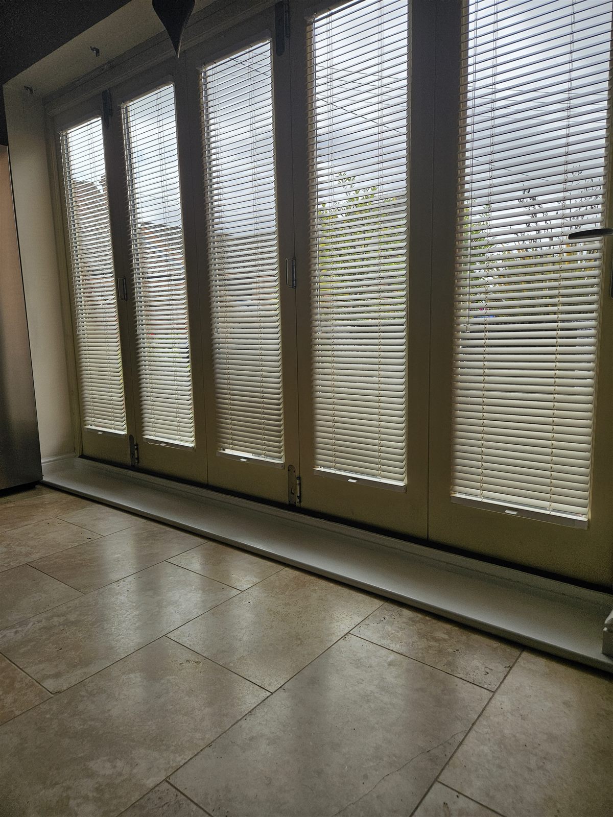 Cream wood venetian blinds fitted to each pane of bi-fold doors by Eclipse SBC in Retford