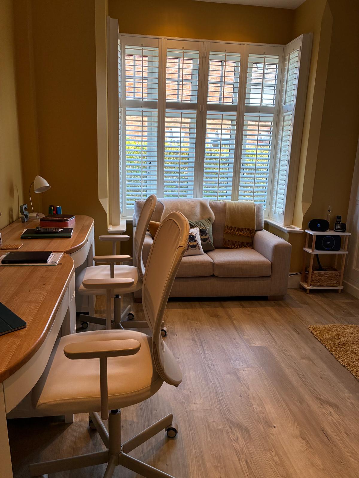 White plantation shutters across an Edwardian bay window in a home library, fitted by Eclipse SBC White plantation shutters across an Edwardian bay window in a home library, fitted by Eclipse SBC