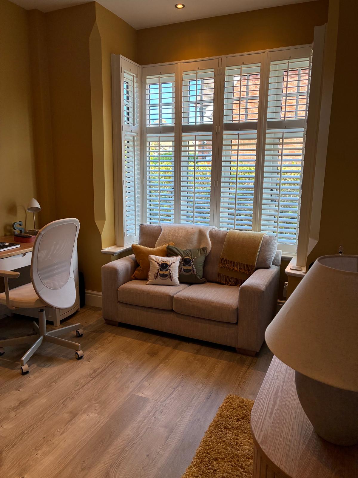 Bay window plantation shutters with 76mm louvres in a home library and office, fitted by Eclipse SBC Bay window plantation shutters with 76mm louvres in a home library and office, fitted by Eclipse SBC