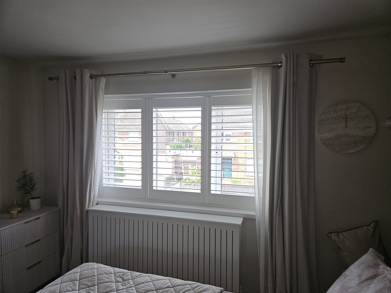 Hampton polyvinyl plantation shutters across a three-panel bedroom window, fitted by Eclipse SBC in Retford