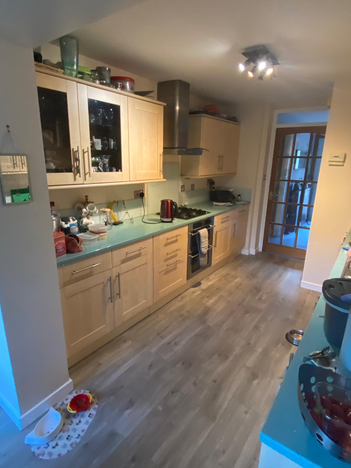 Kitchen before: maple doors and teal worktop