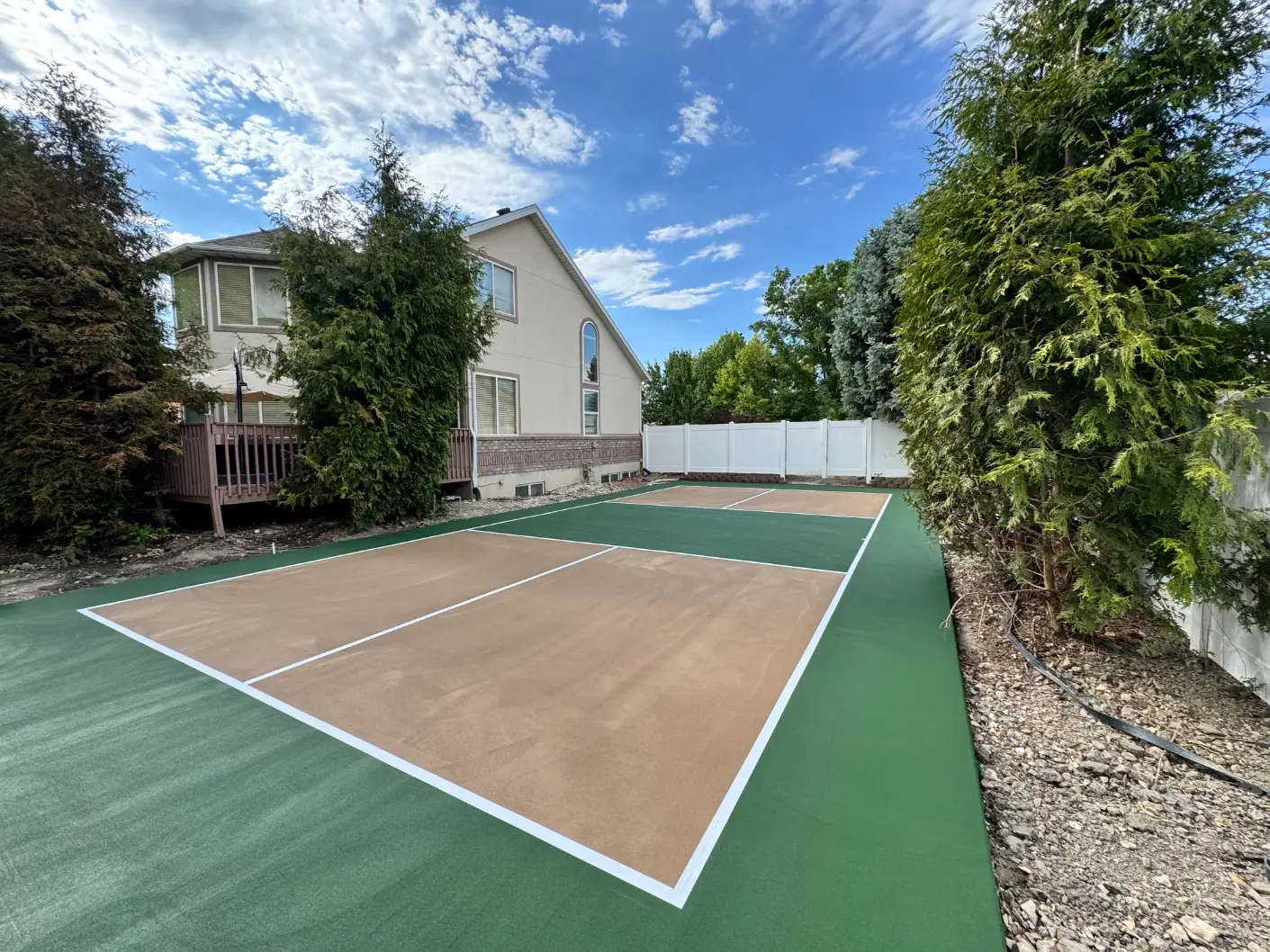 Residential pickleball court with green and light brown color combination
