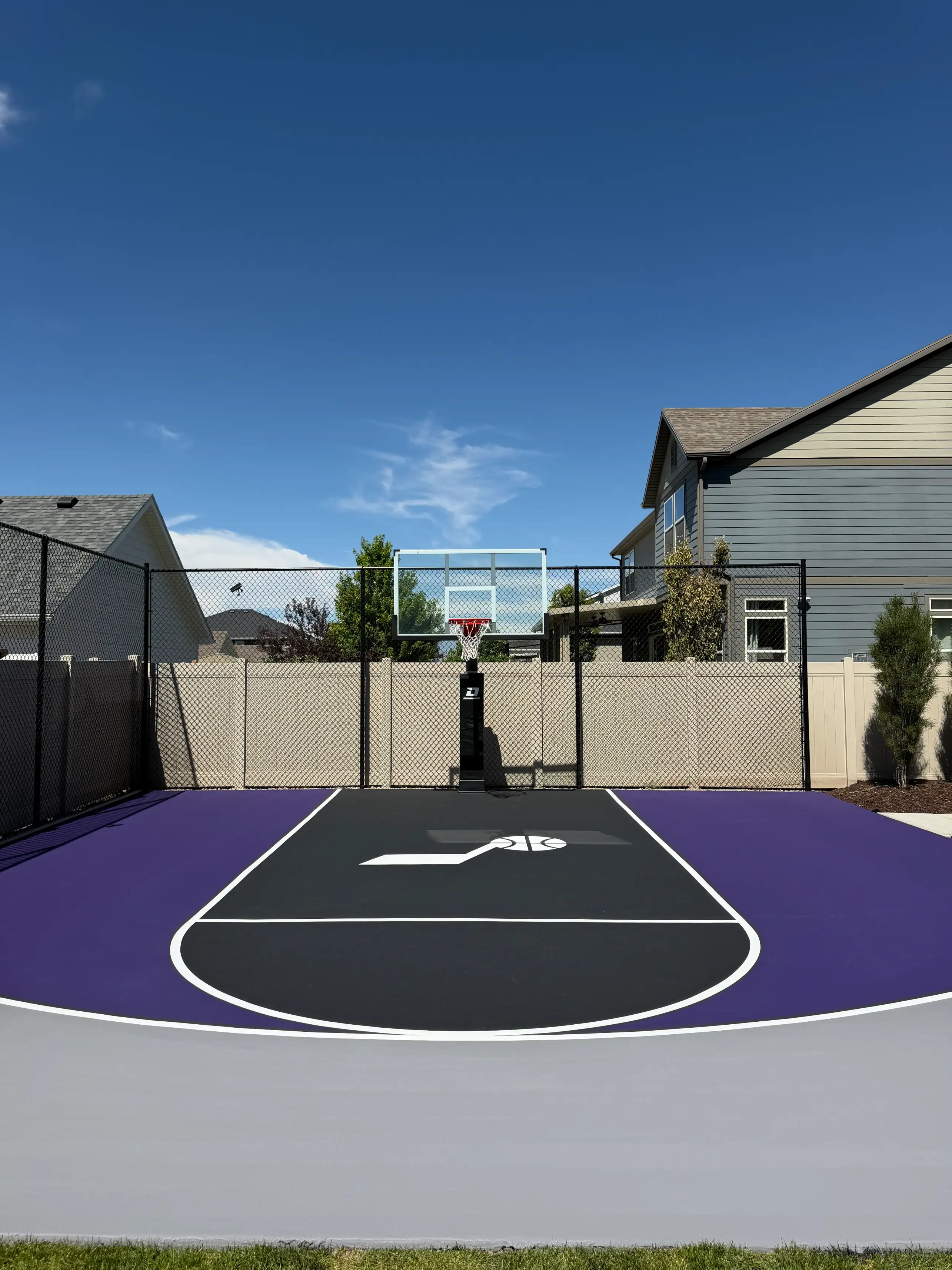 Purple and black basketball half court with custom center logo and grey border