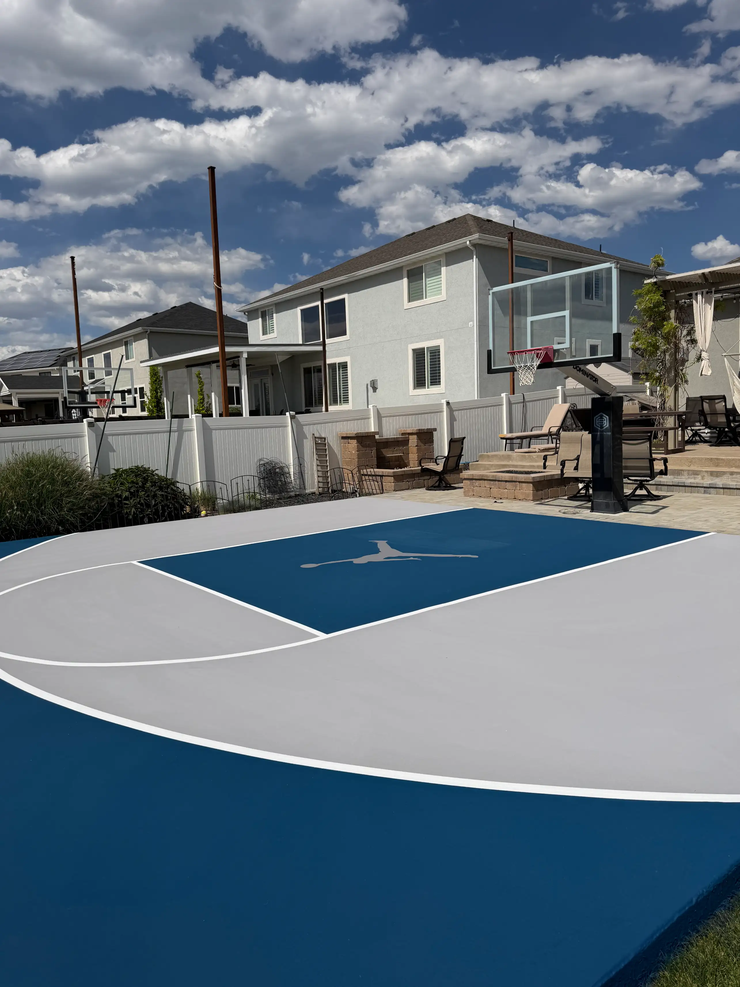 Blue and light grey basketball half court with custom logo in the key