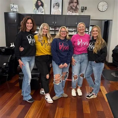 The Salon Bliss team in their bliss shirts, standing together in the salon