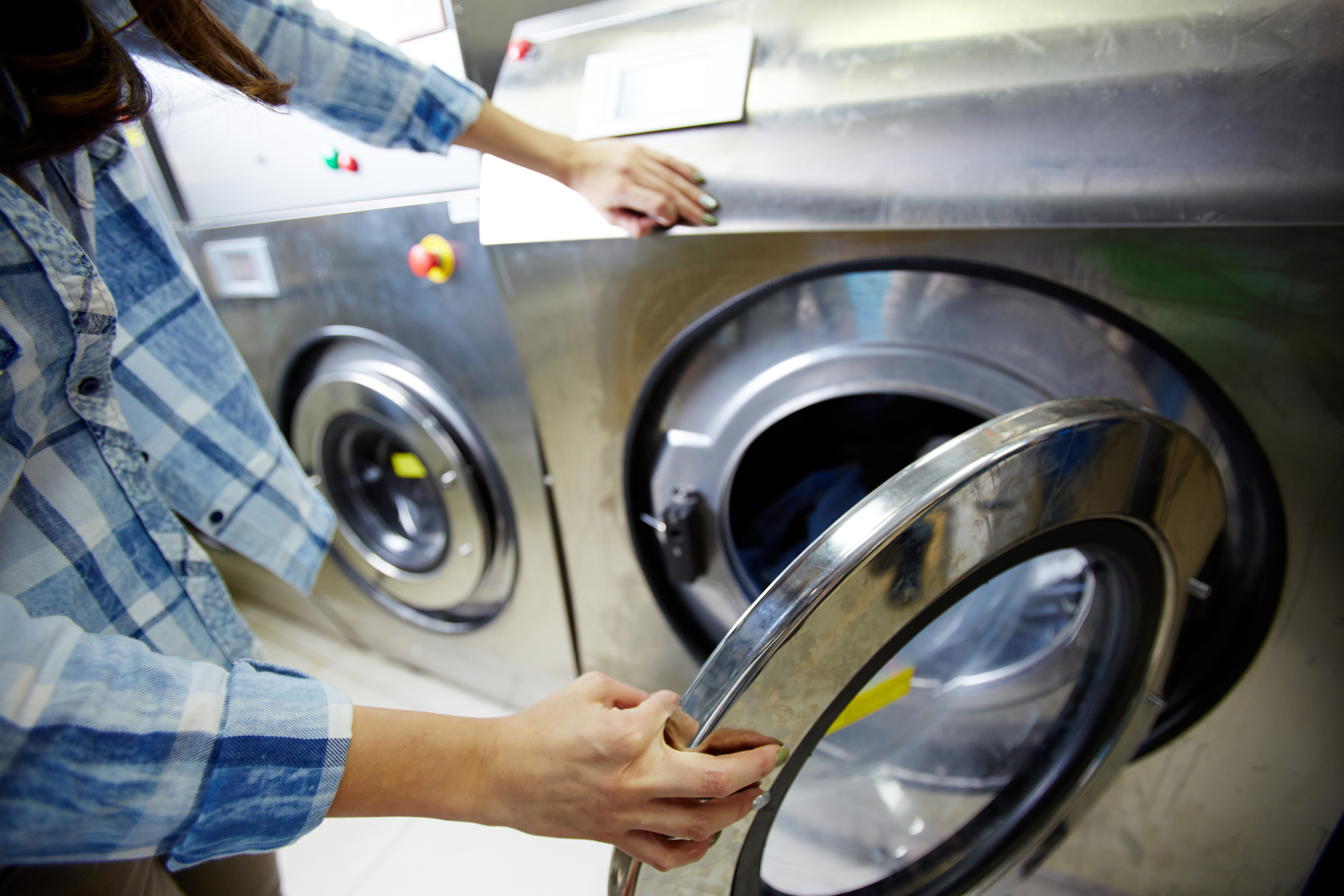 Plumber connecting a washing machine water supply and waste pipe