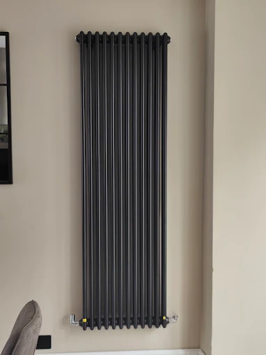 Plumber fitting a replacement radiator
