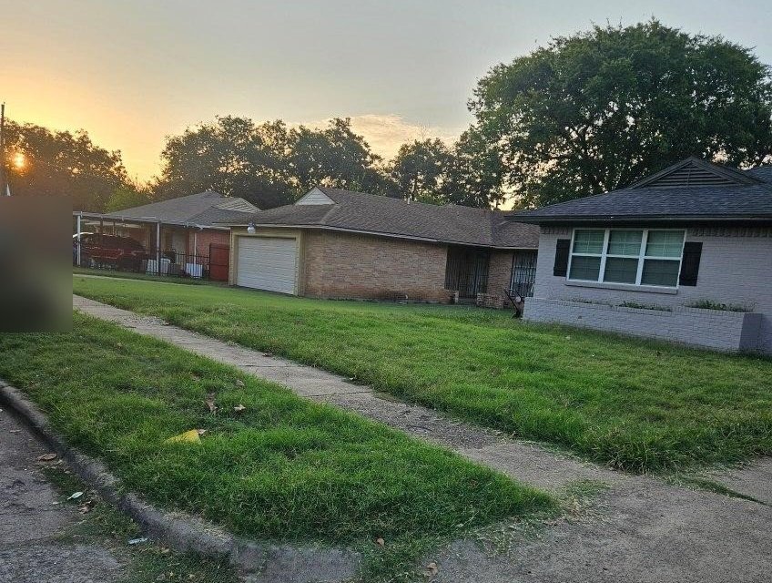 Street view at sunset of the same house and neighboring homes. Representative photo of a different property, not the Oak Street sample.