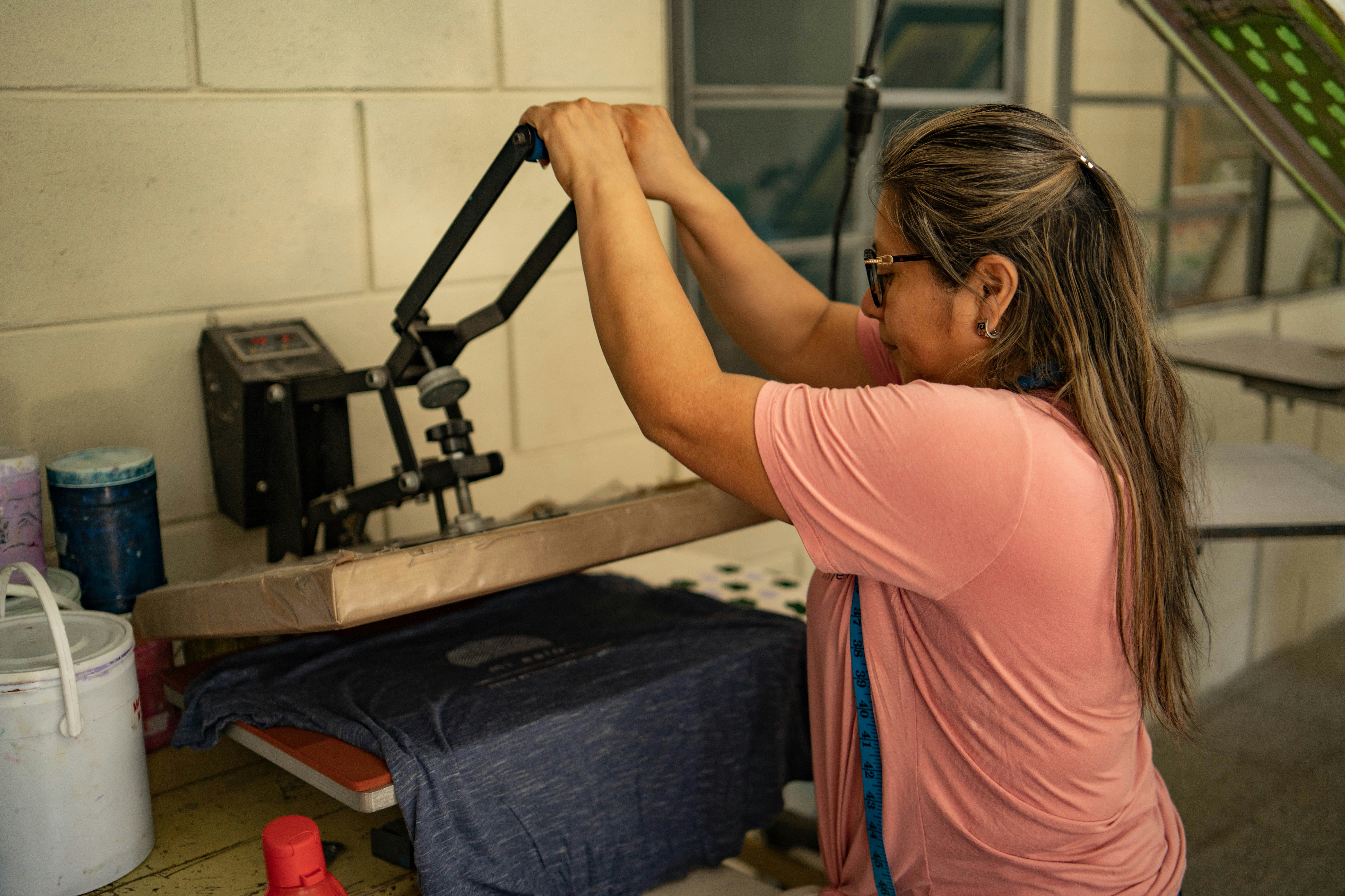 Photoof woman using thermal tshirt press