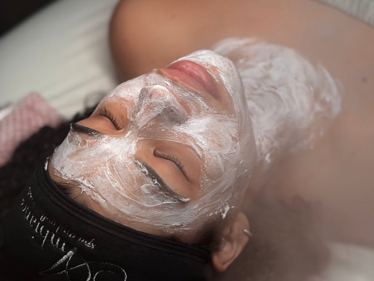 Client relaxing with a custom mask during a facial at Ambiance Spa in Northwest Houston