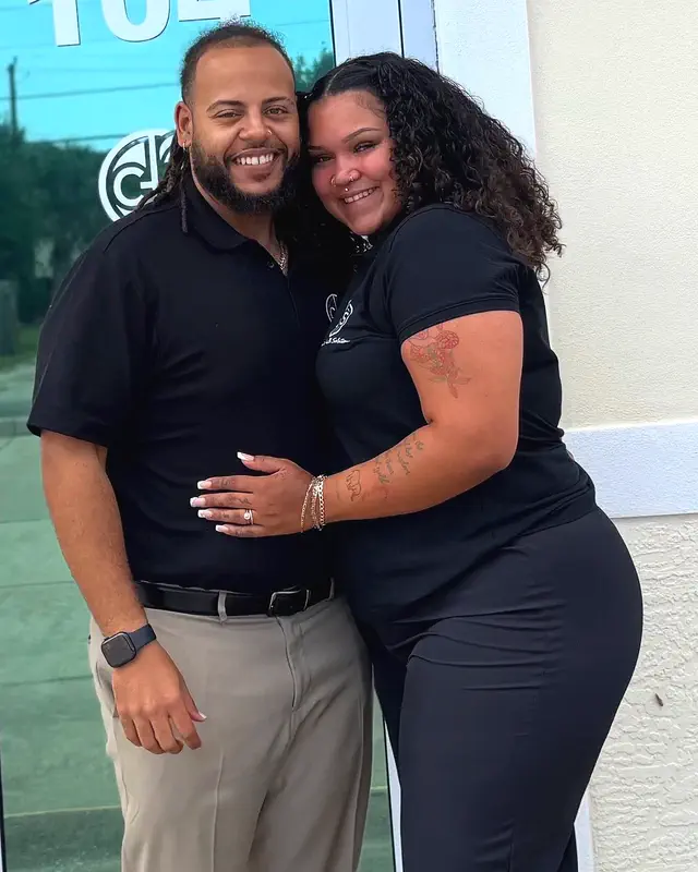 Darius Mills, founder of Creative Health Solutions, with his wife Kiyanna outside the office at suite 104