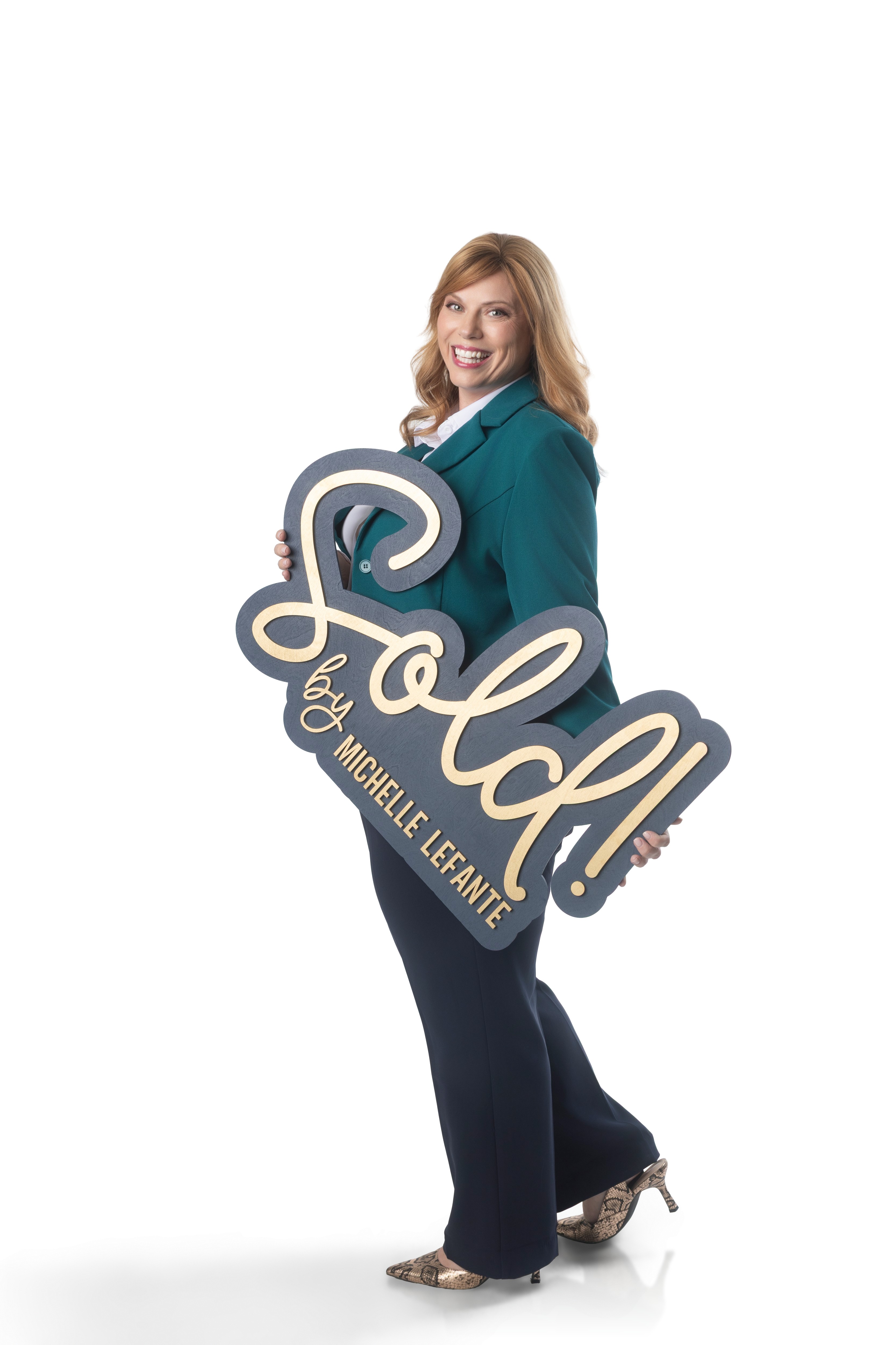 Michelle LeFante holding a Sold by Michelle LeFante sign