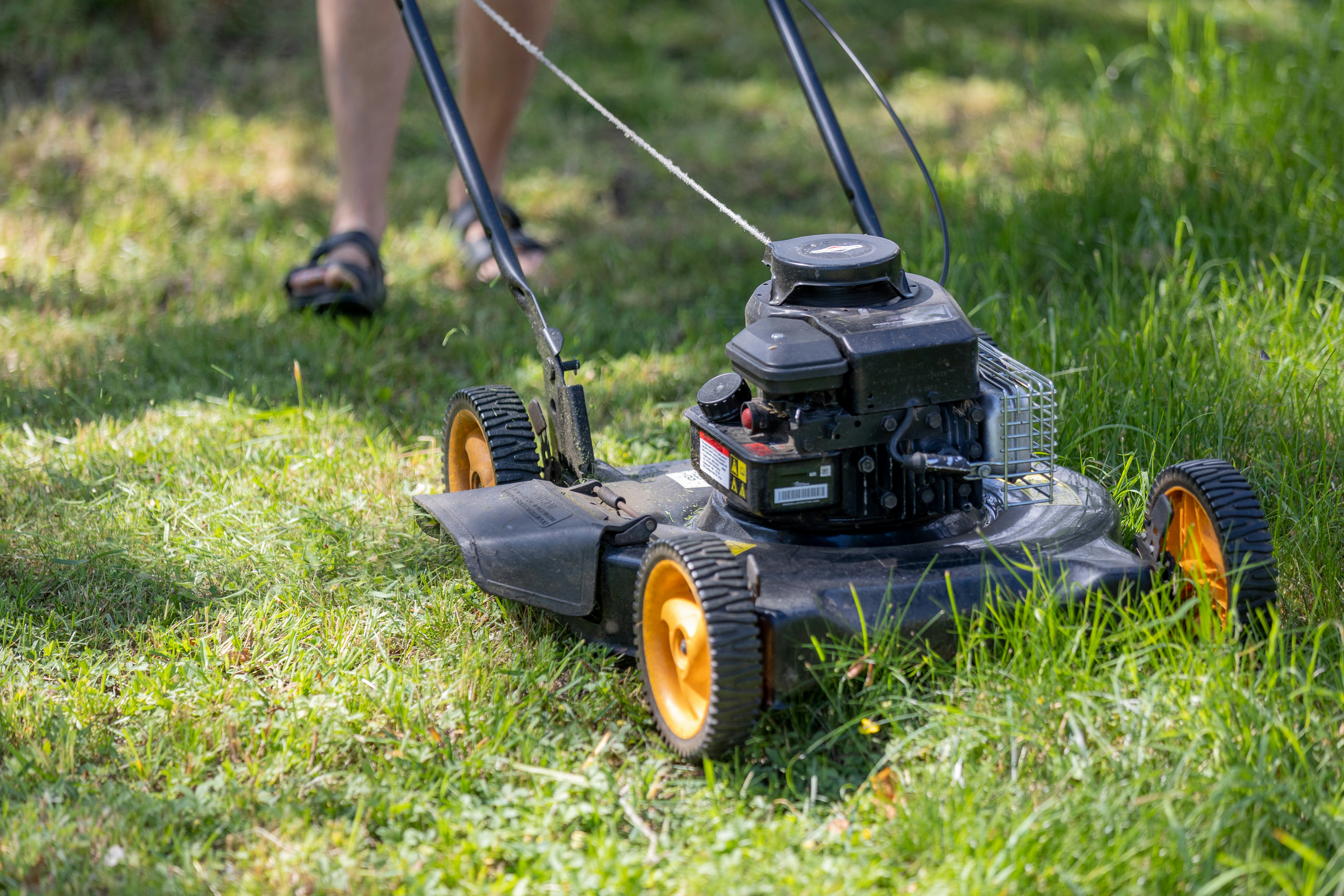 Lawn mower cutting a fresh edge into grass