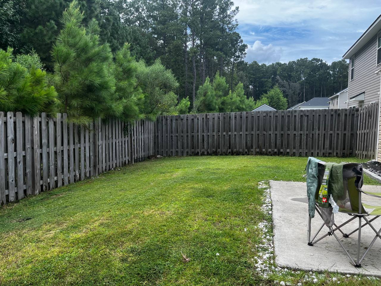 Well-maintained backyard lawn with fenced border
