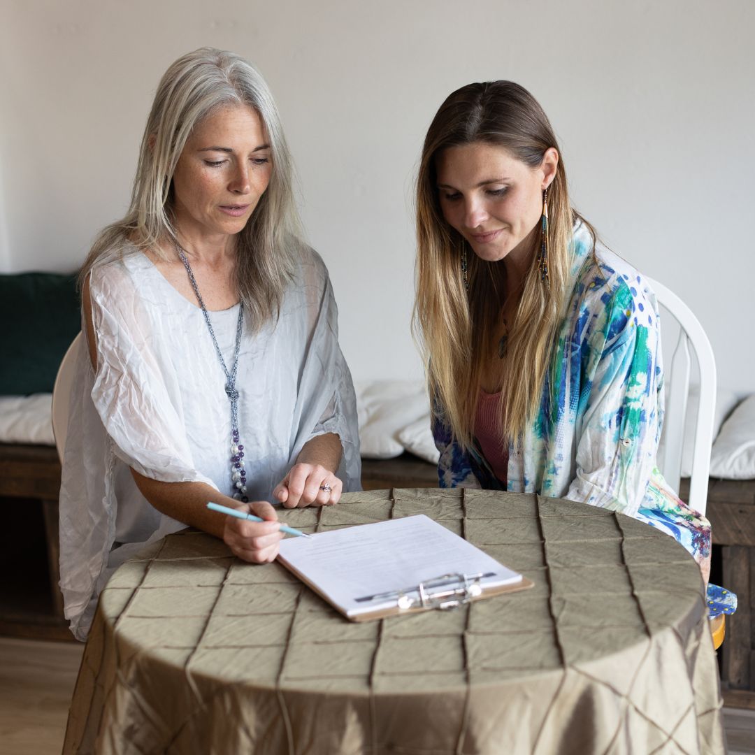 Brandy reviewing a spinal chart with a client