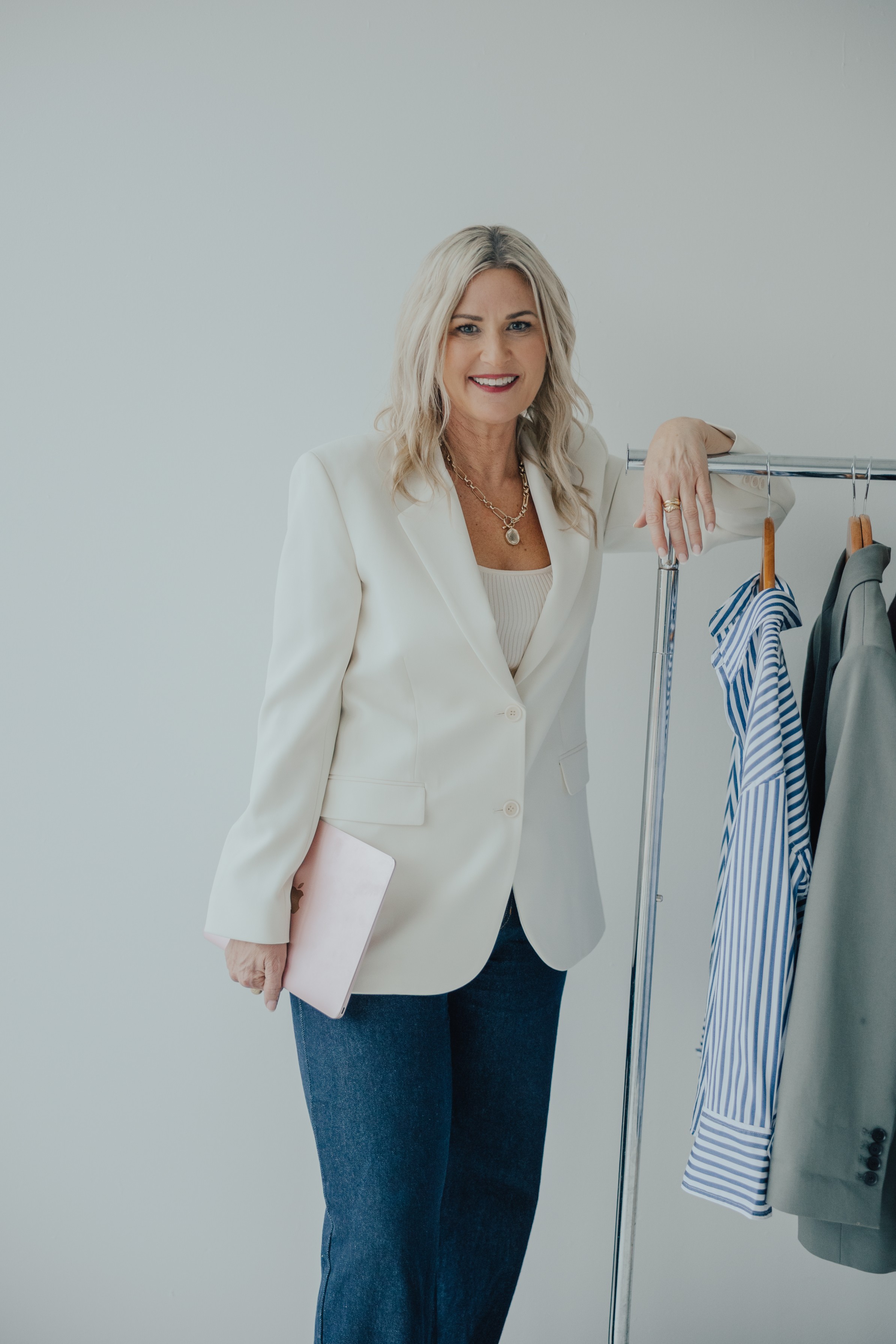 Melissa Armitage Auckland personal stylist standing beside clothing rack in Get In Touch page