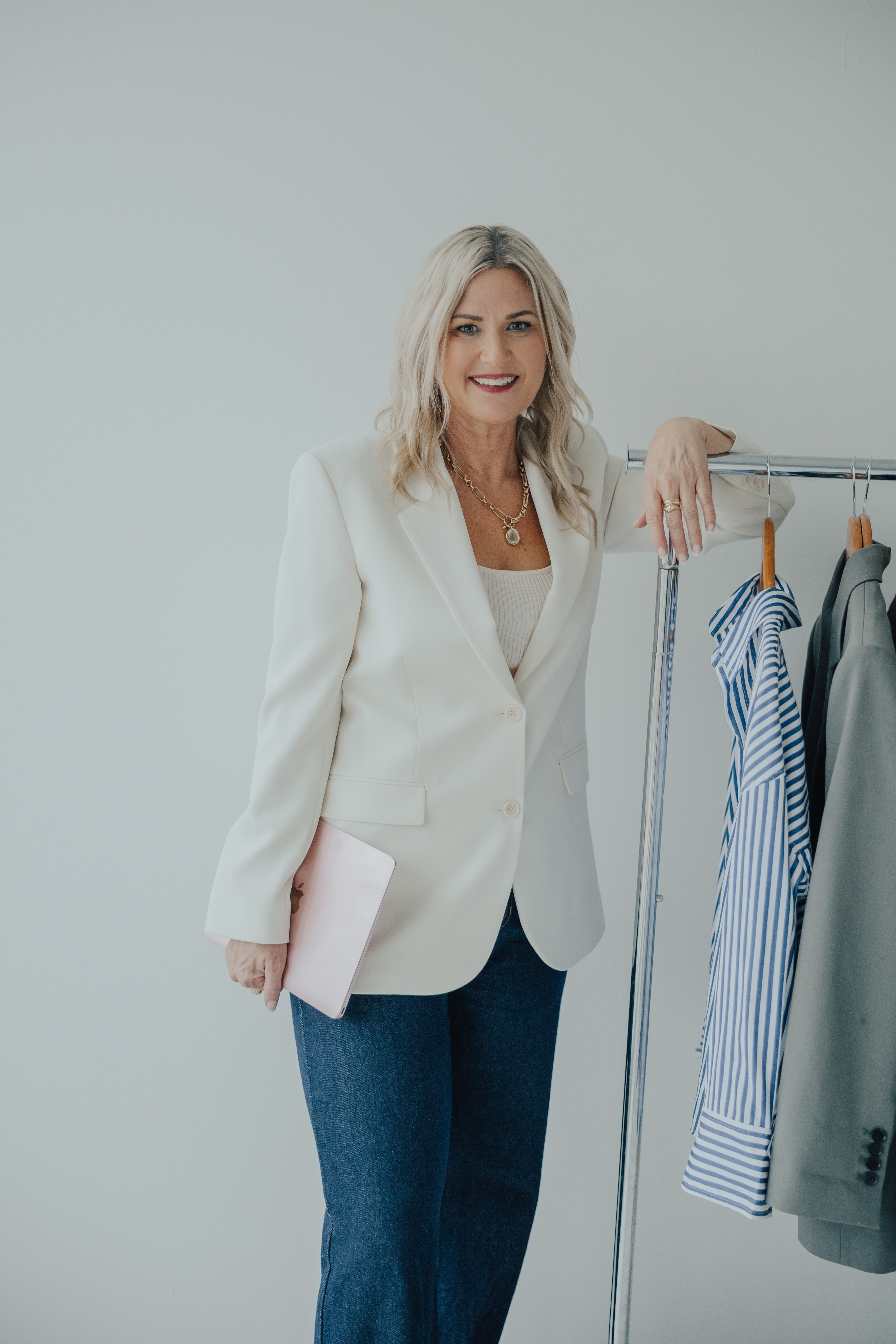 Melissa Armitage Auckland personal stylist standing beside clothing rack in Get In Touch page