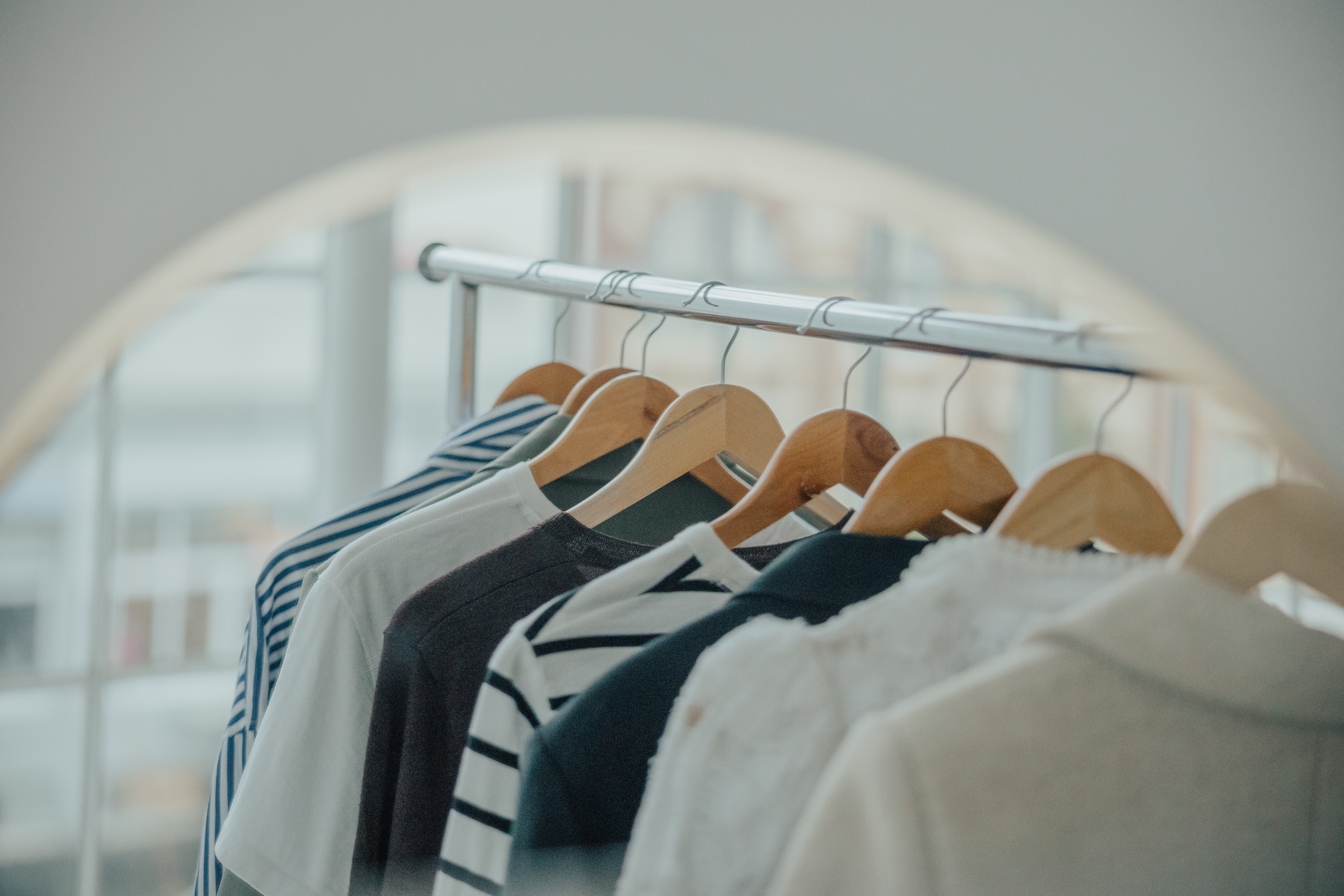 Capsule wardrobe and seasonal outfit collection on clothing rack