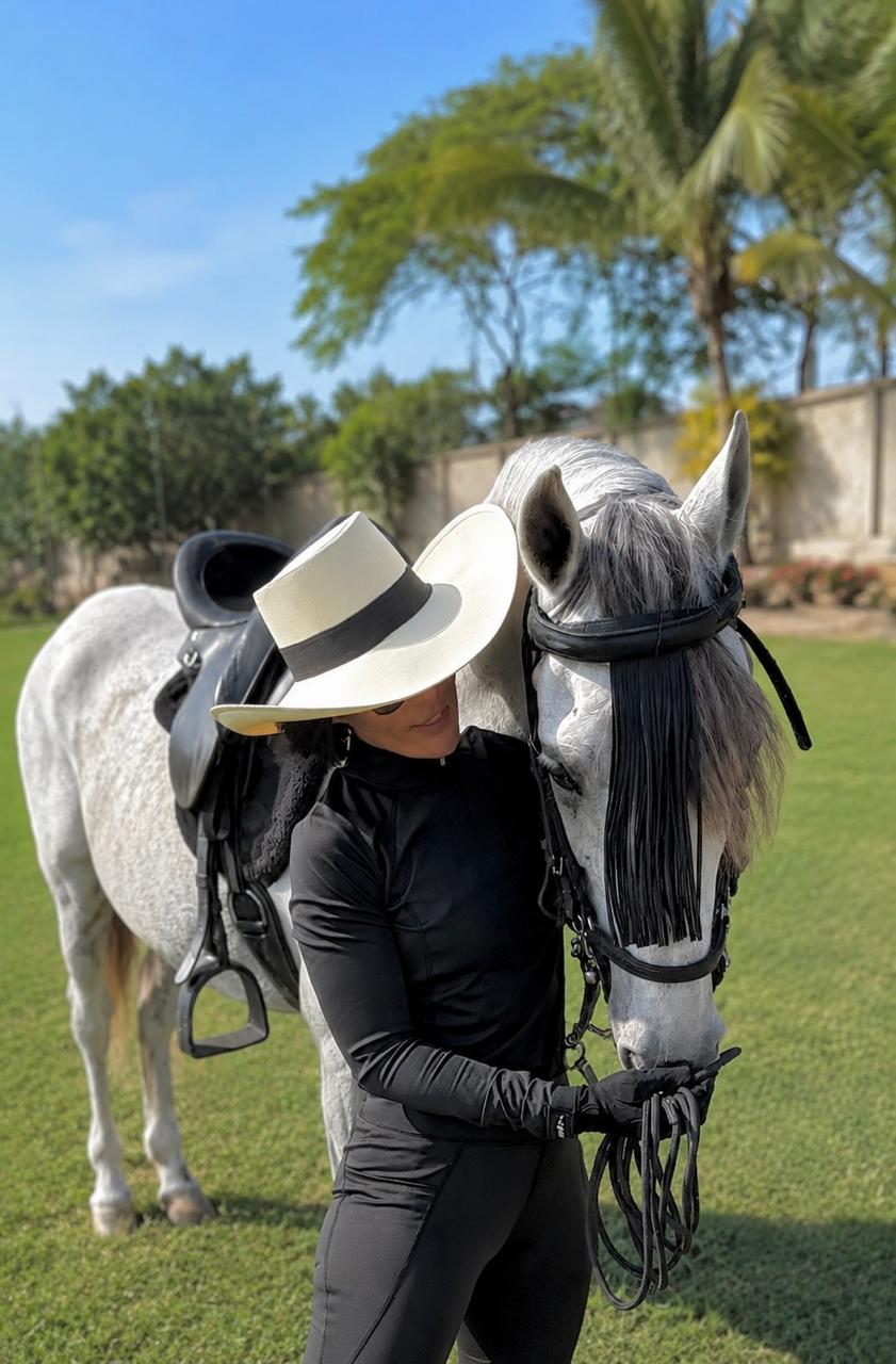 Caballo blanco de Fauné Finca Club junto a una visitante