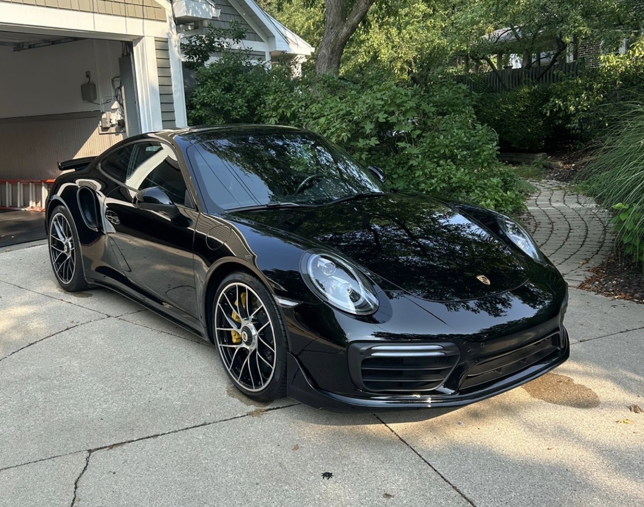 Black porsche 911with a ceramic coating applied to it.