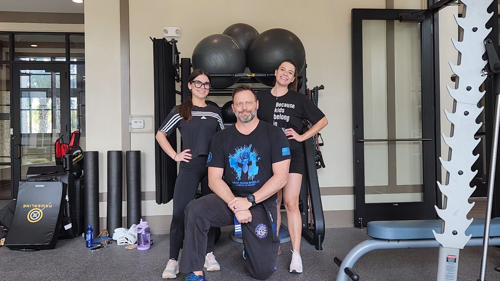 Jason Mertin with two clients after a training session, all smiling
