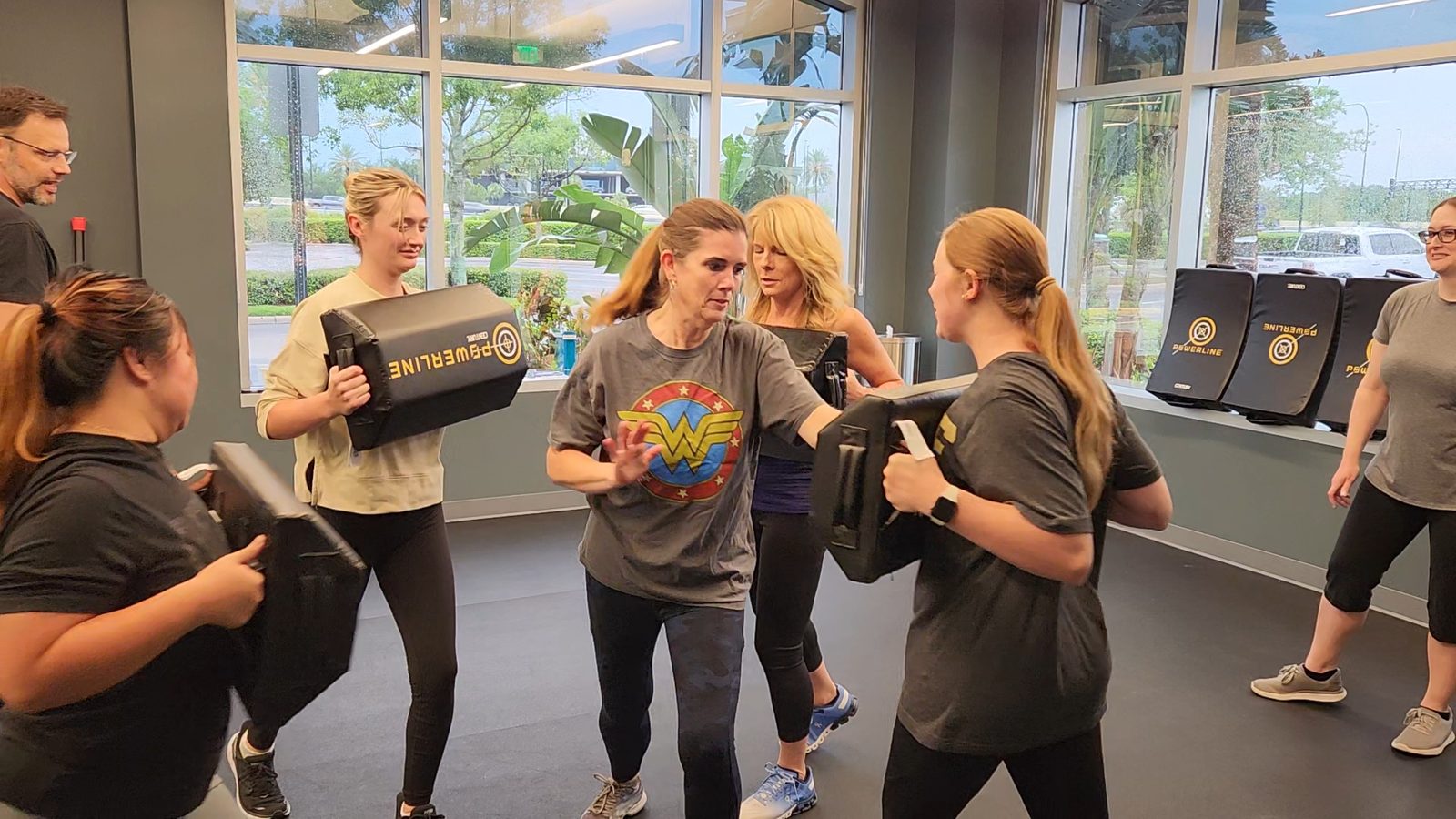 A women's small-group class practicing pad drills together