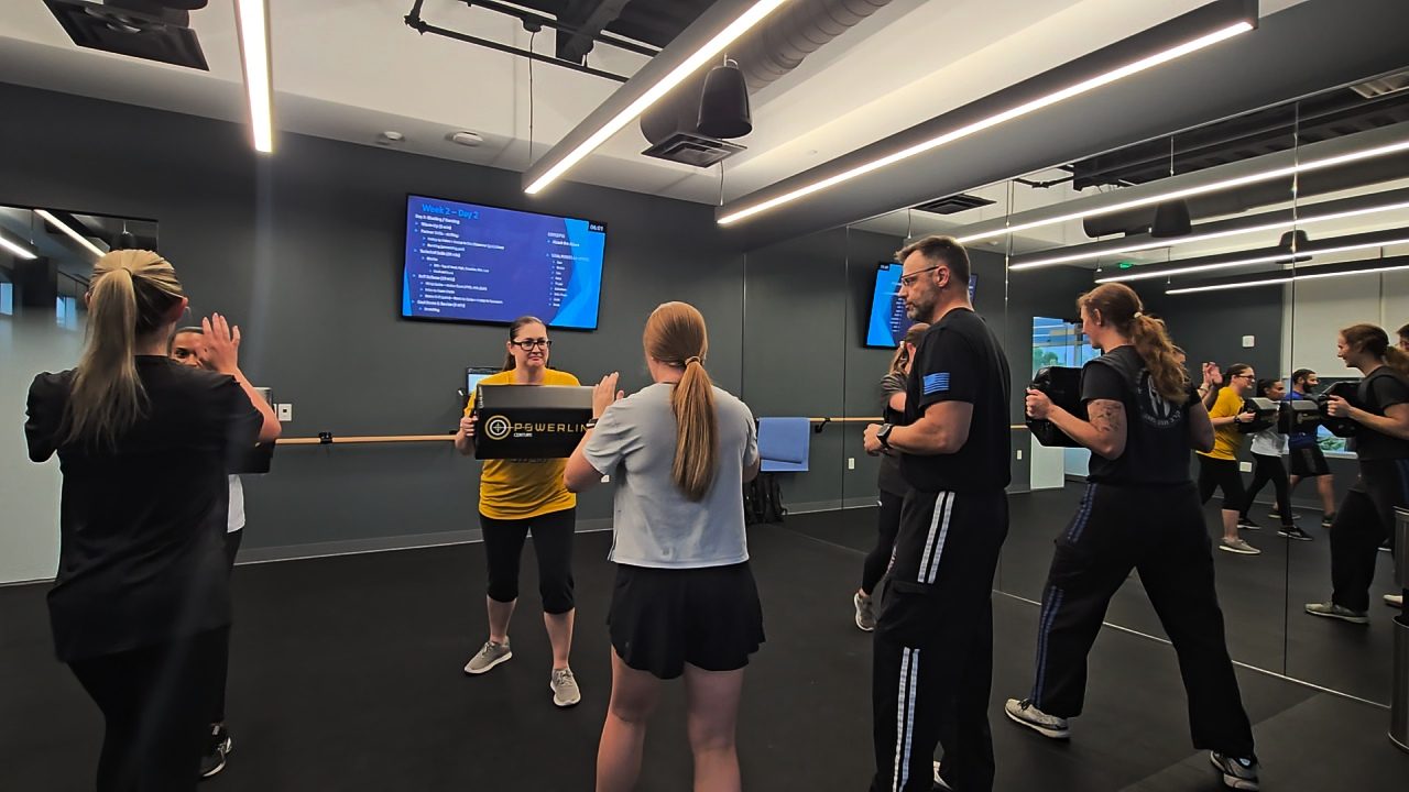 A focused partner drill during a Krav Maga session, working a close-range release
