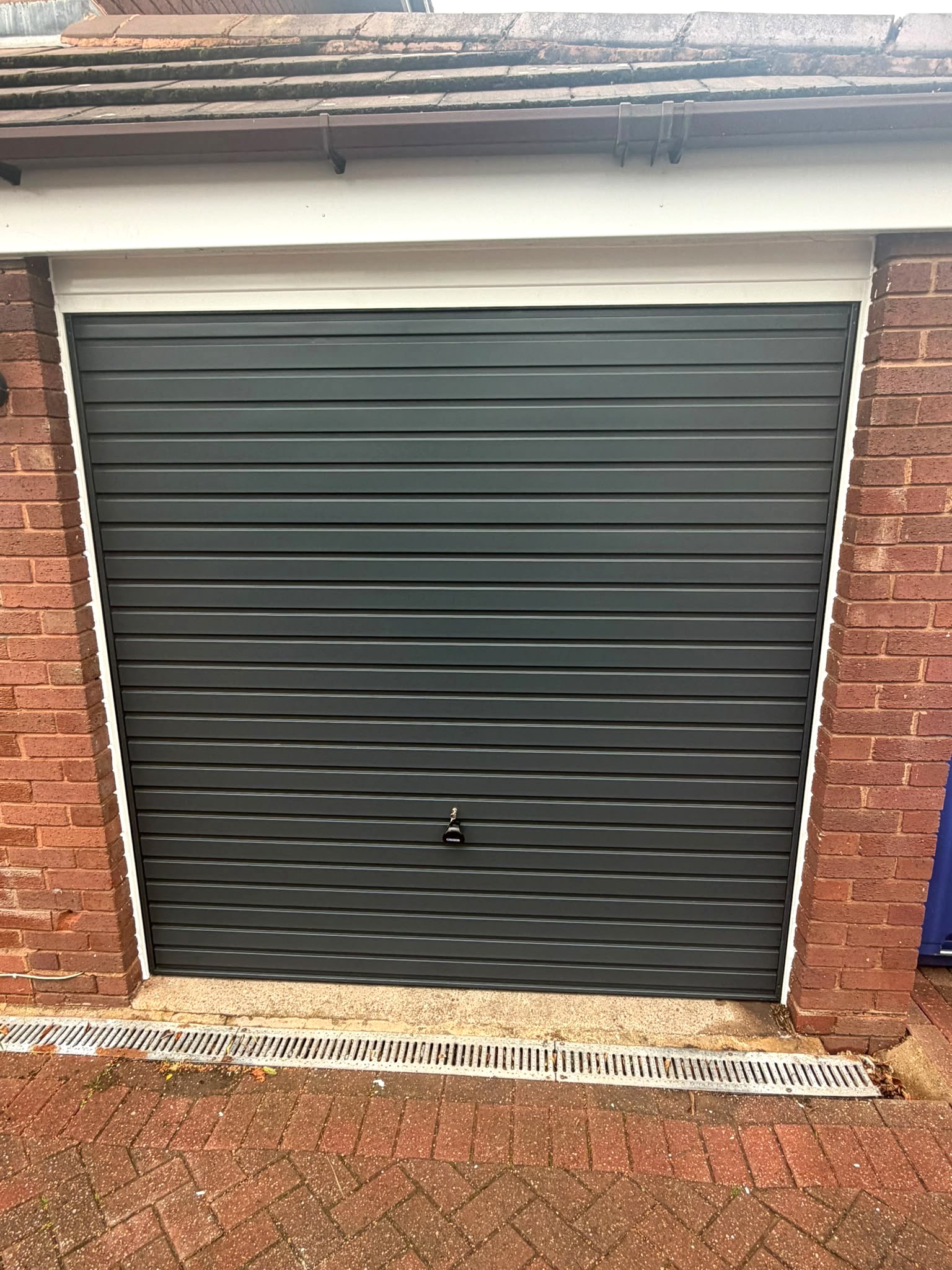 Before and after installation of an anthracite grey Garador Up & Over garage door in Dudley by Central Garage Doors