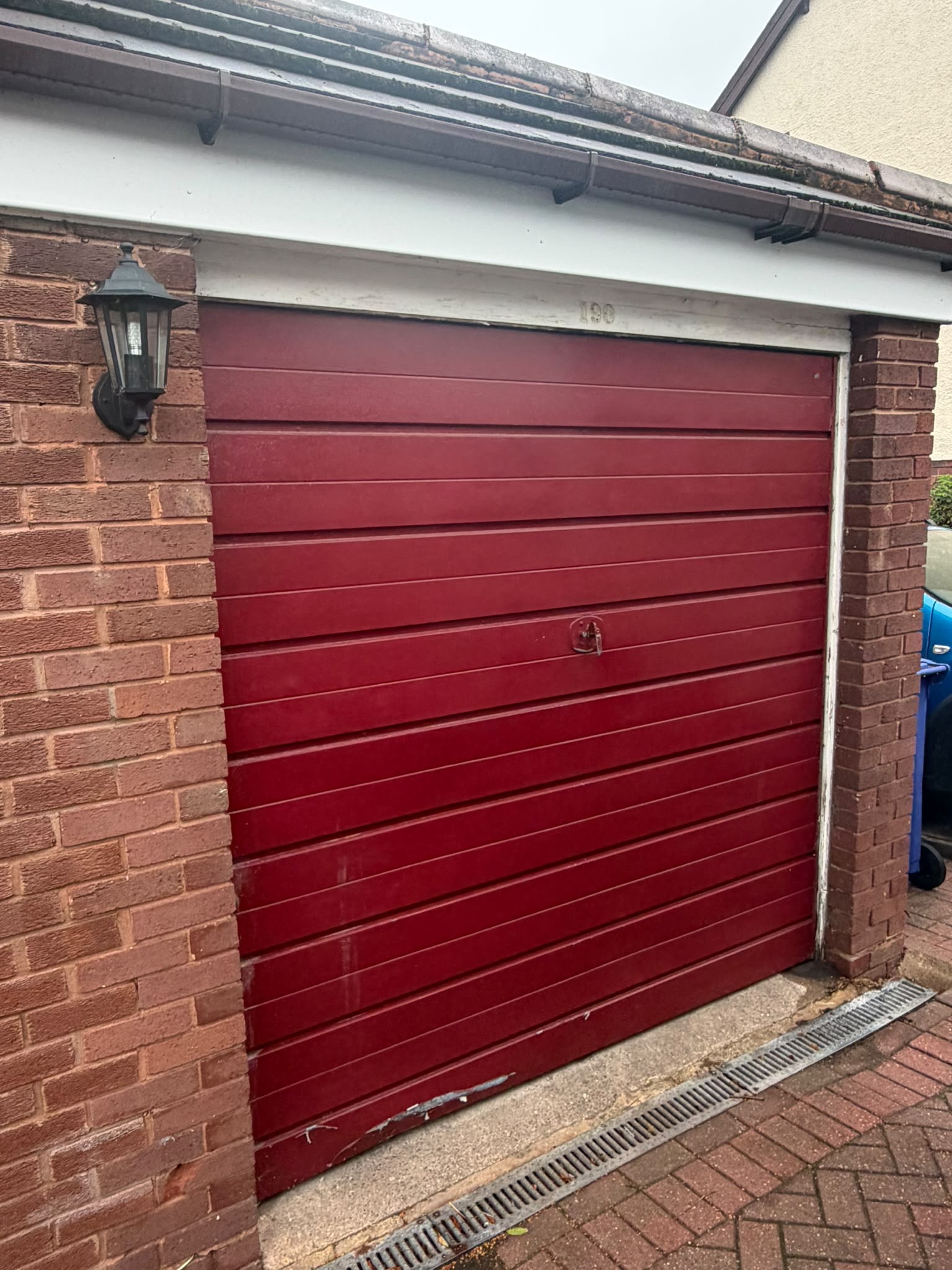 Before and after installation of an anthracite grey Garador Up & Over garage door in Dudley by Central Garage Doors.